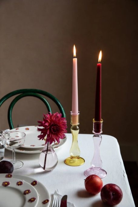 Table set with pink and yellow candlesticks and pink and red candles