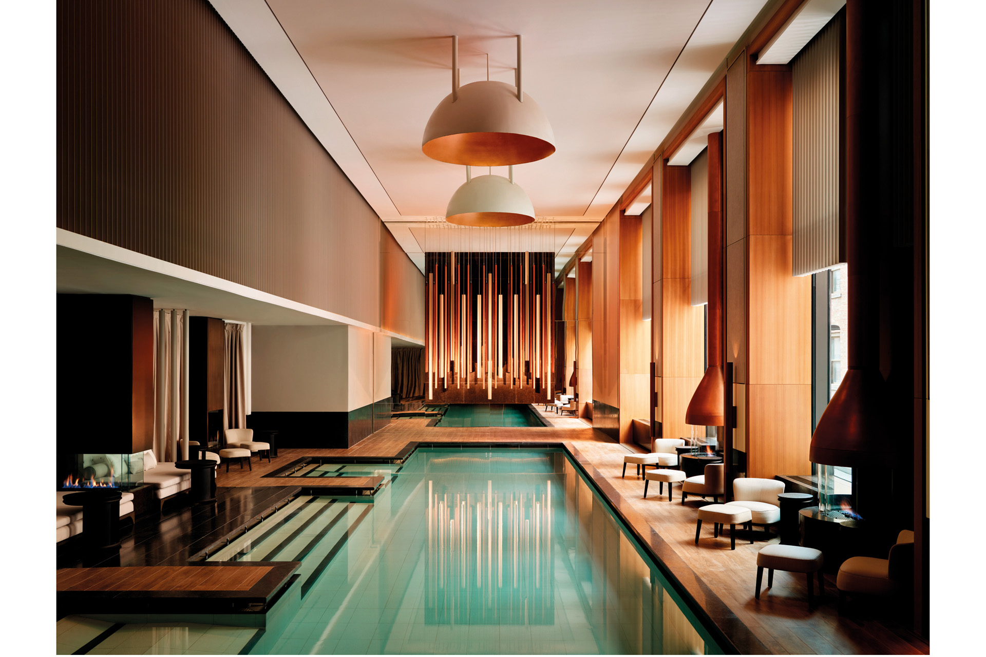 a serene spa with straight lines, amber walls and still pool