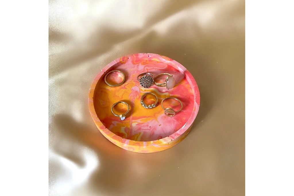 Colourful jewellery dish on satin backdrop