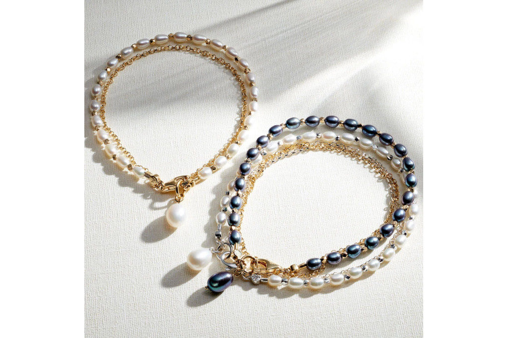 Two pearl bracelets on neutral surface