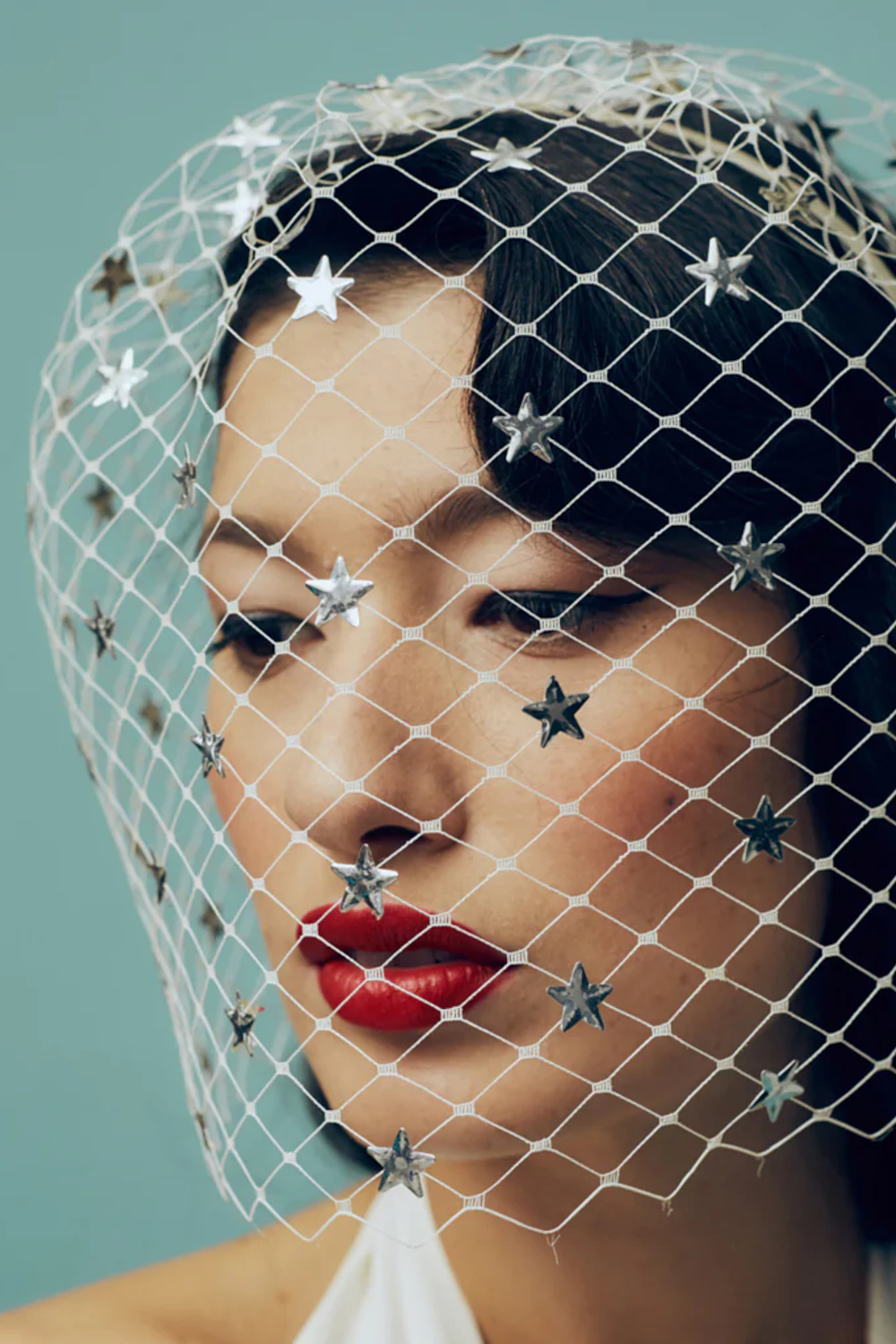 Woman wearing mesh headpiece with stars