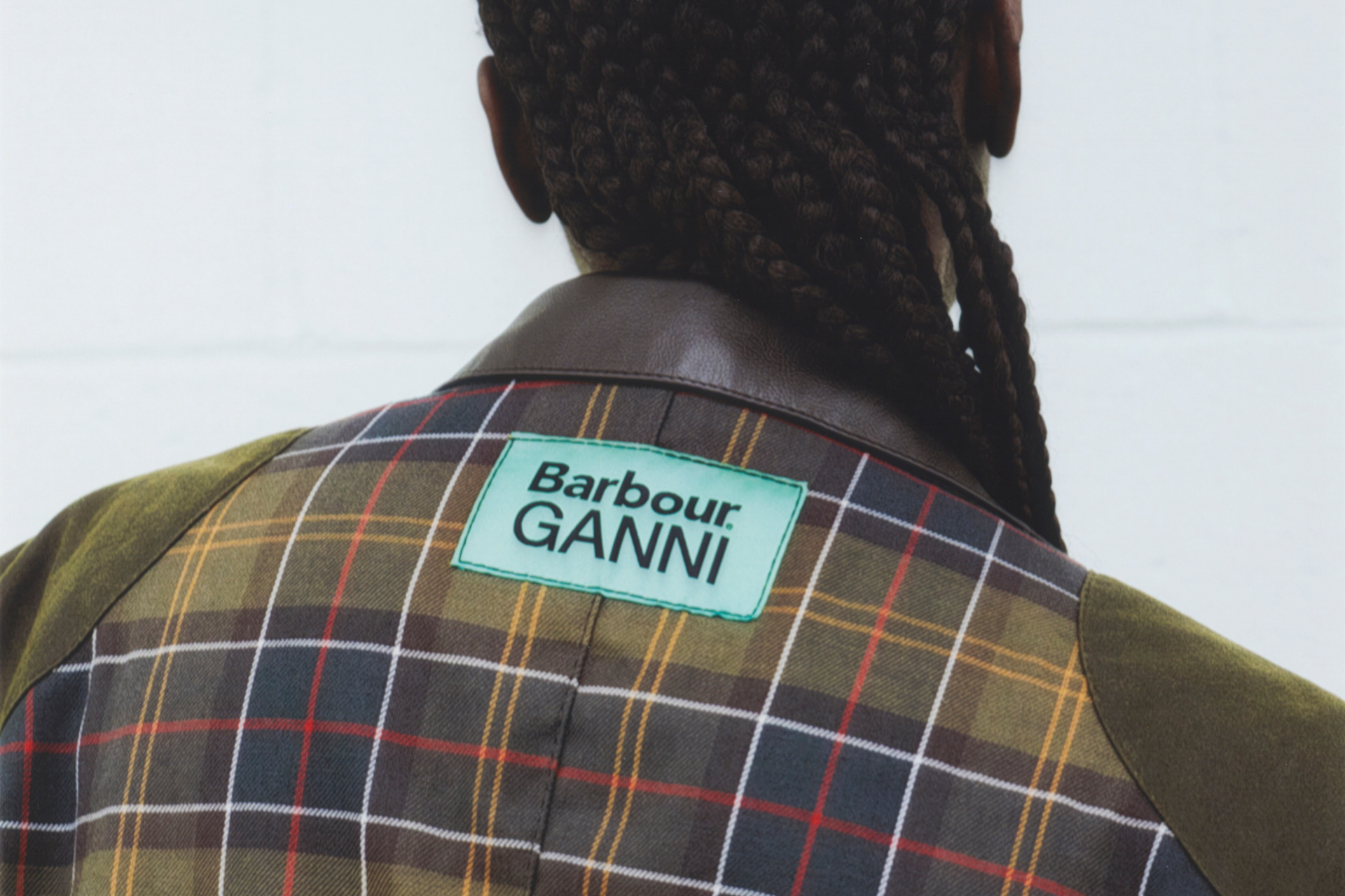 Close up of the back of a check jacket with a Barbour GANNI label