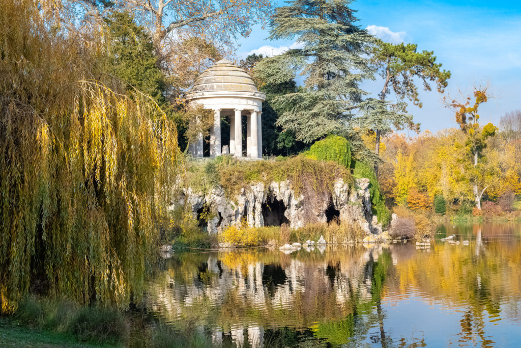 Vincennes, the temple of love and artificial grotto on the Daumesnil lake, in the public park, in autumn