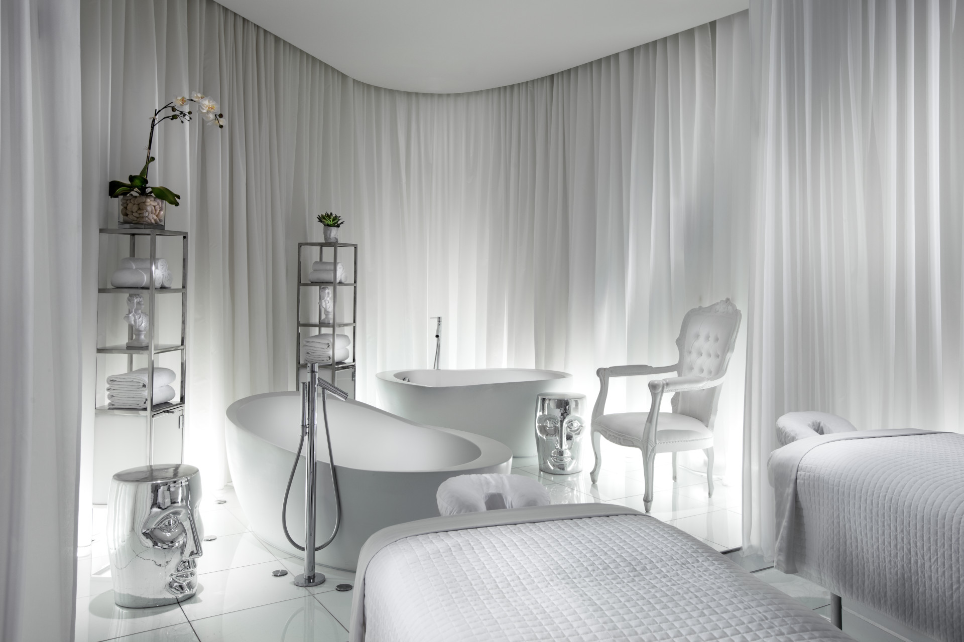 White room with treatment spa beds and baths