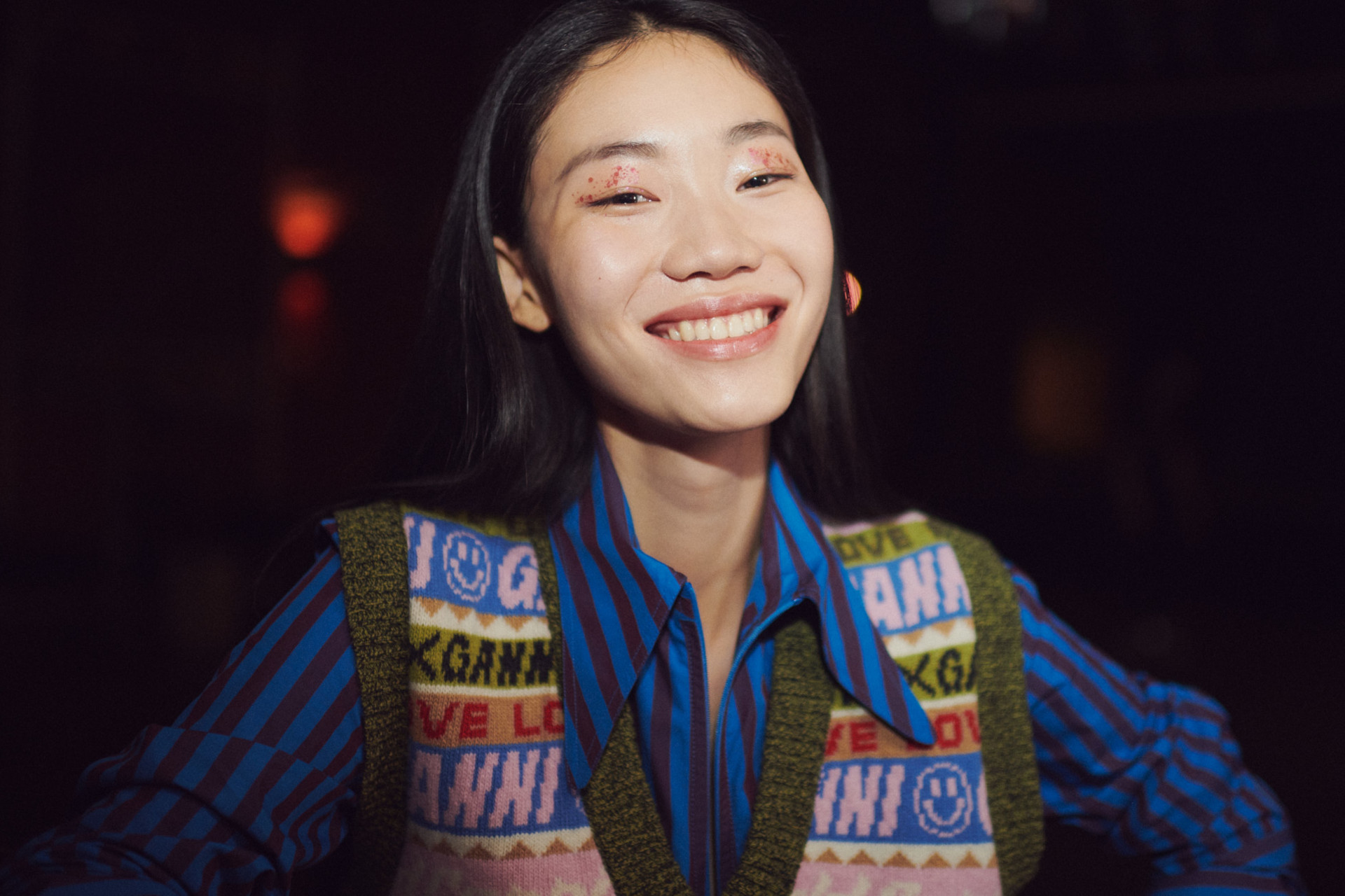 Woman smiling with glitter on her eyes