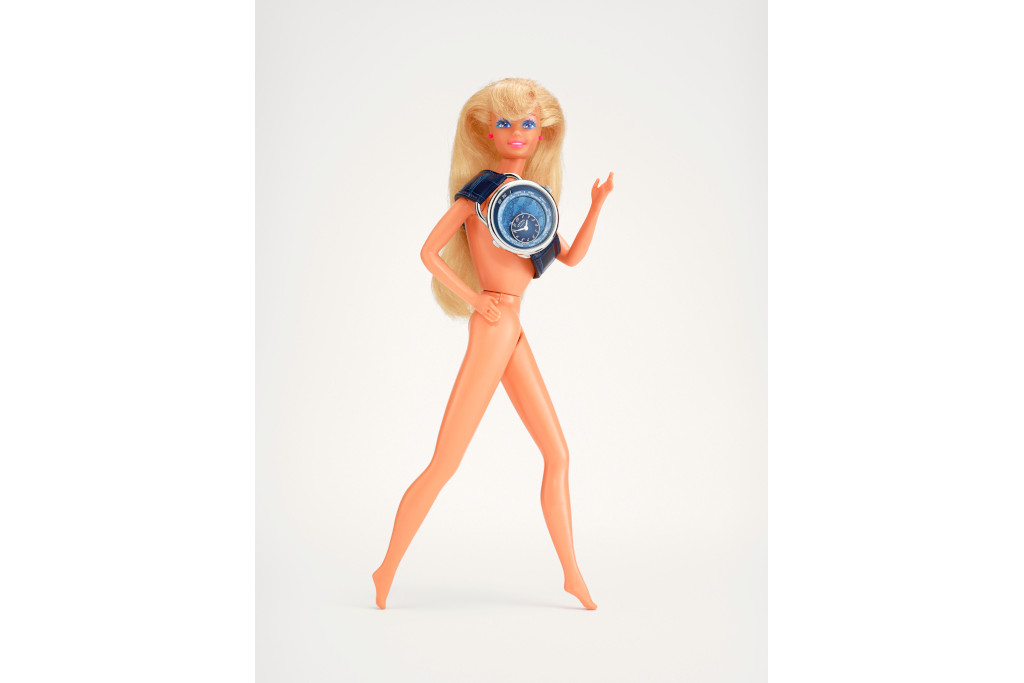 Vintage doll with a watch around its shoulders