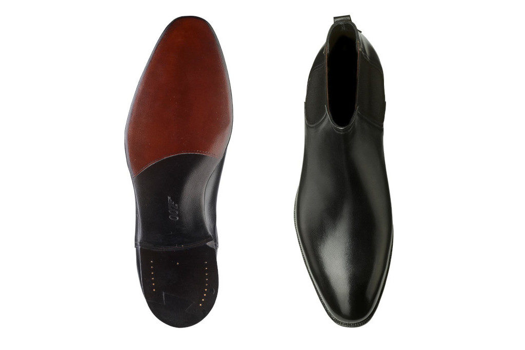 Black shoes in dark room with 007 printed on the soles