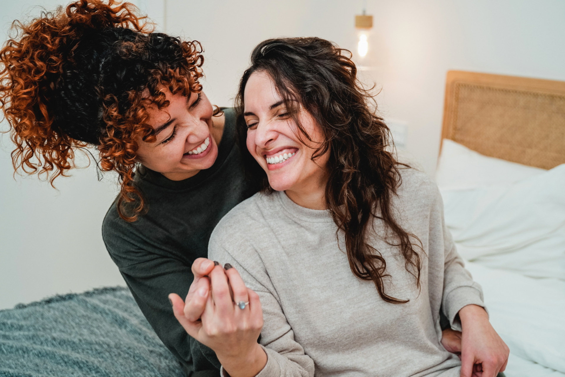 Two woman sat together in jumpers