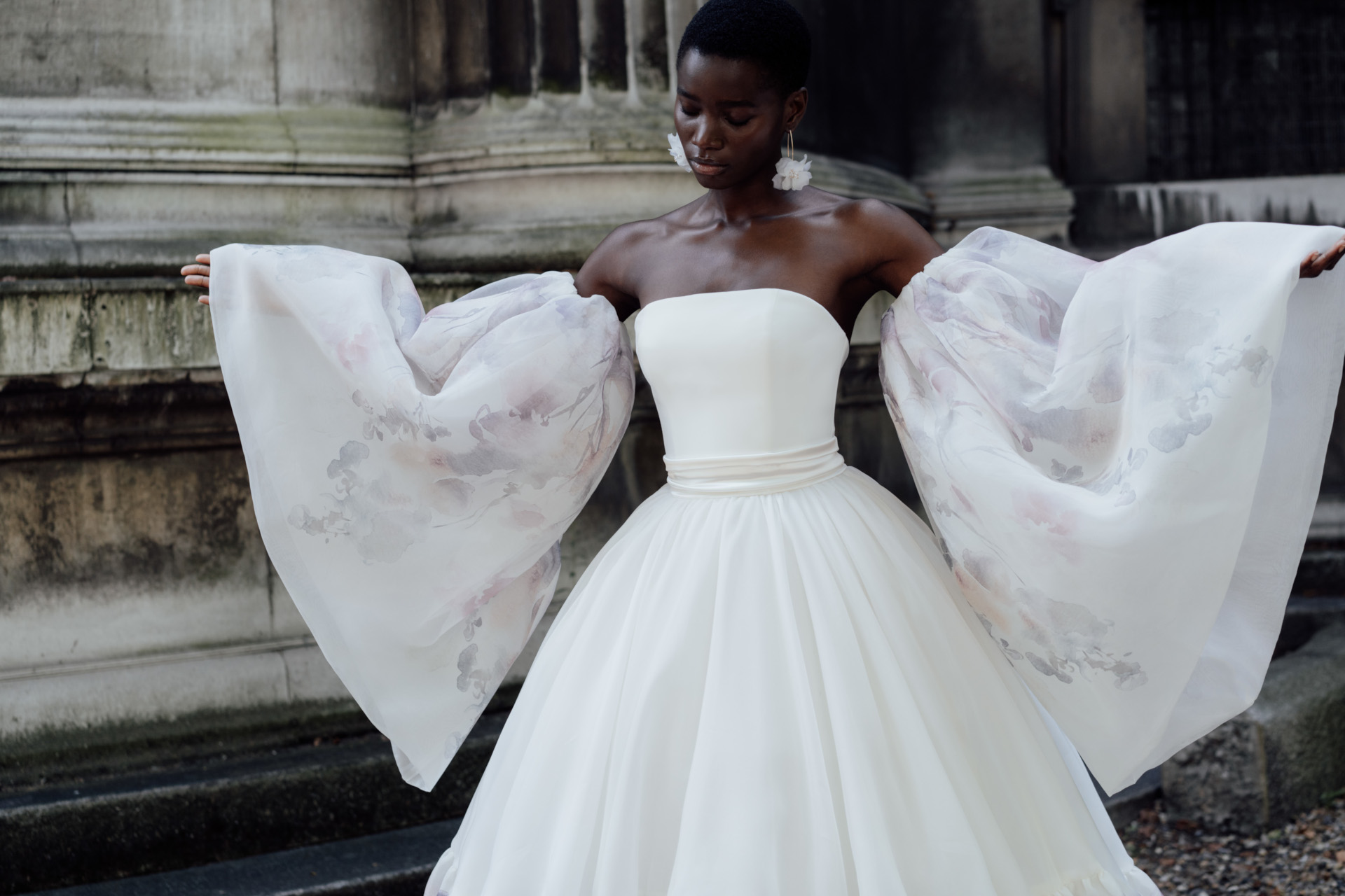 Woman wearing white ball gown with long sleeves