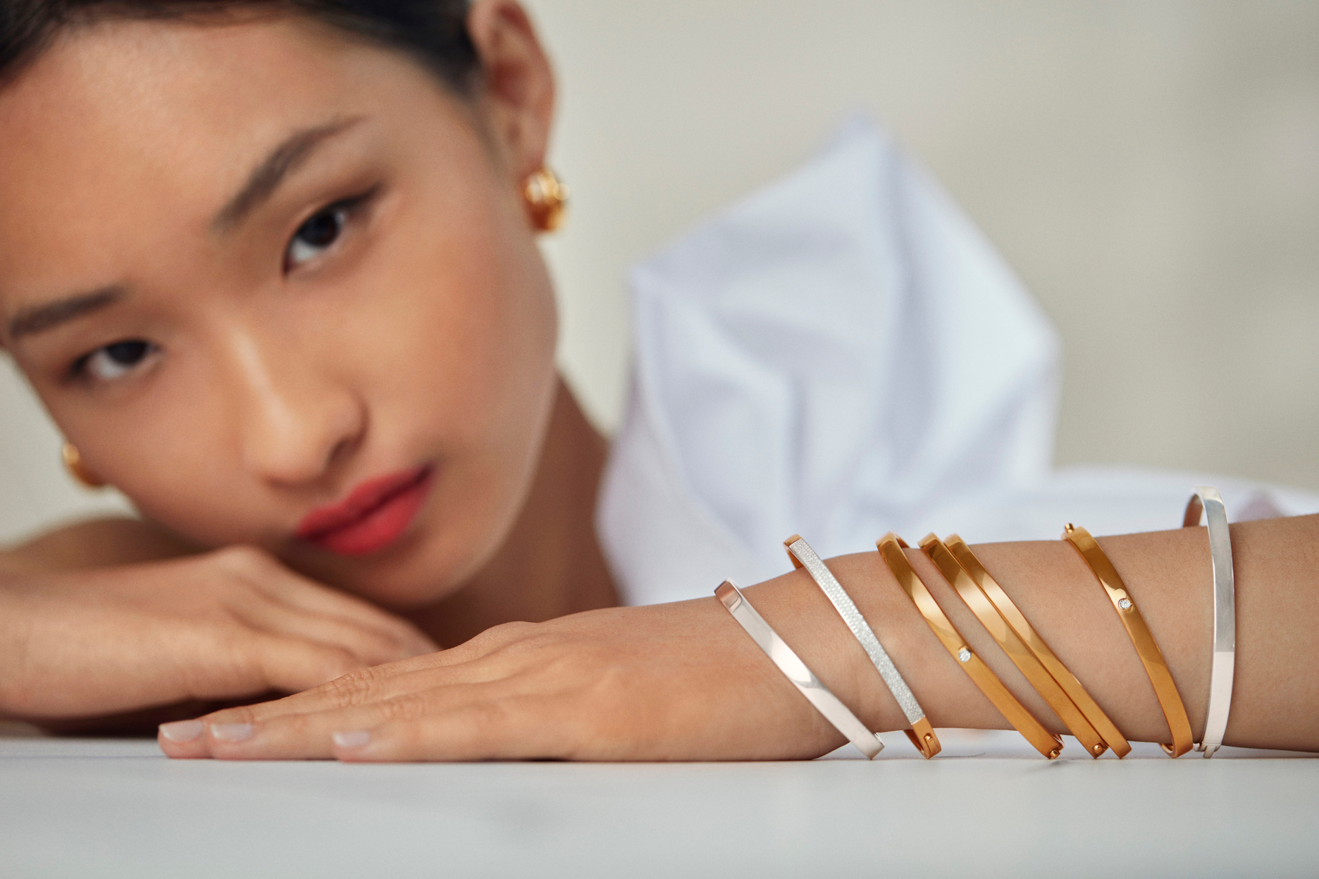 Close up of woman leaning on her arms, which are stacked withbangles