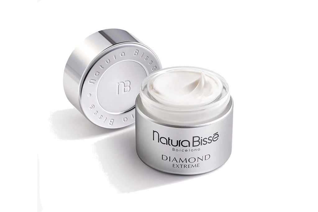 Open silver tub of face cream with lid