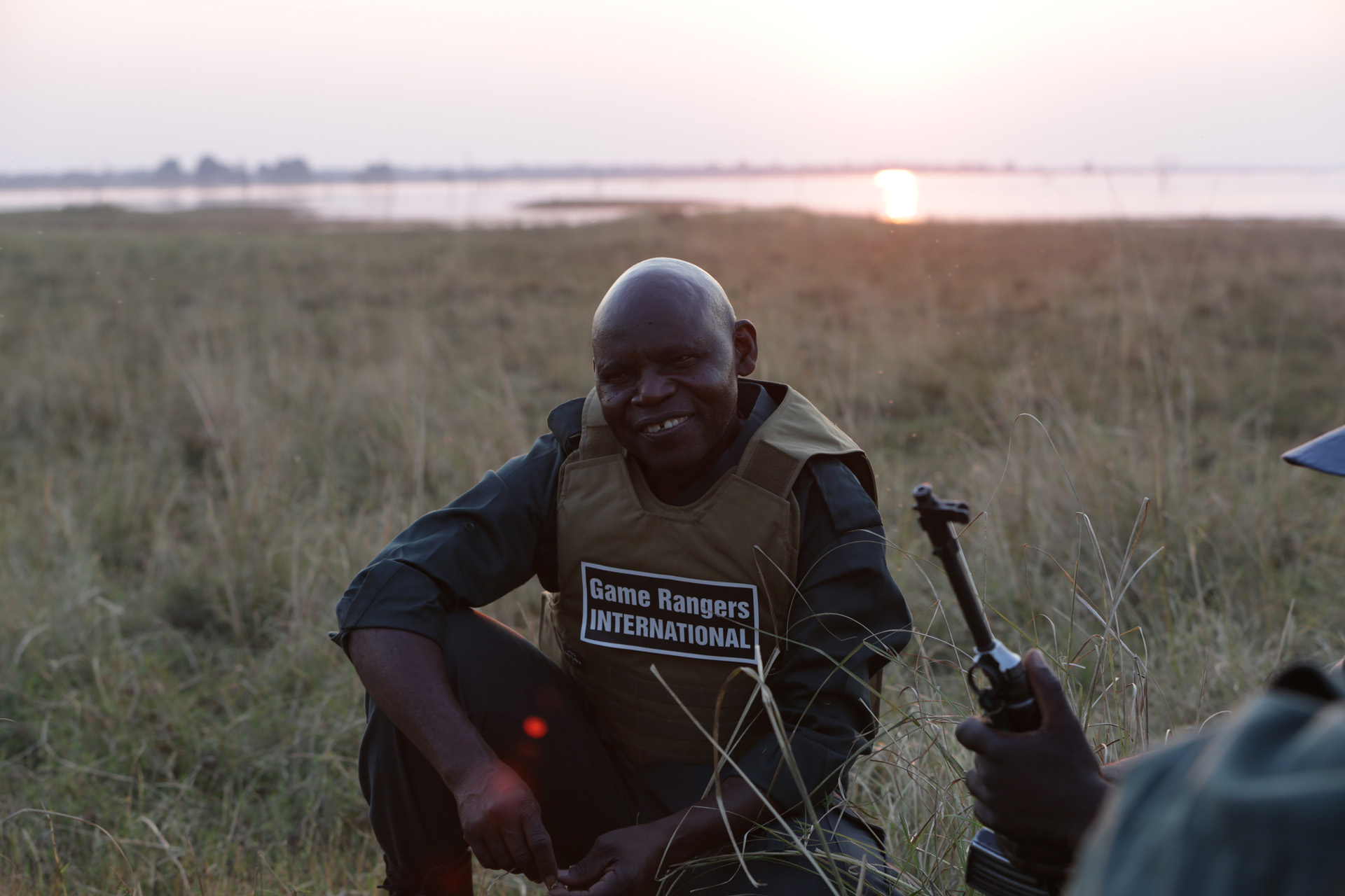 Neddy Mulimo on an African plain with a sunset behind him