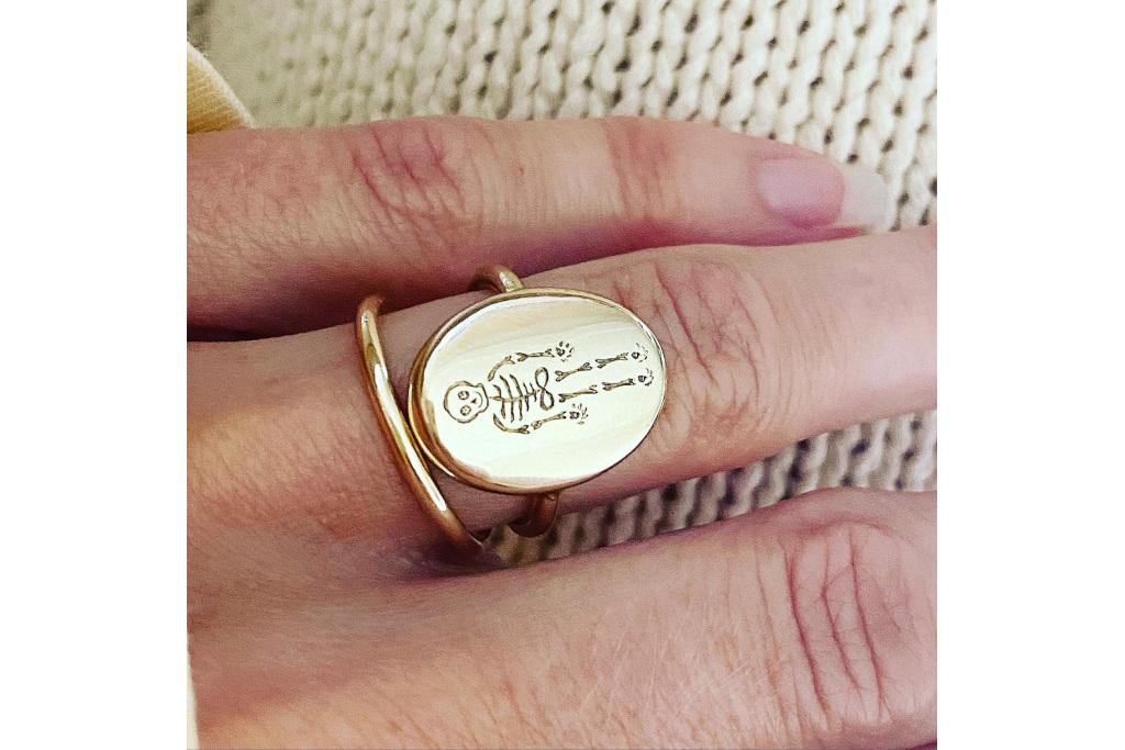 Close up of hand wearing skeleton ring