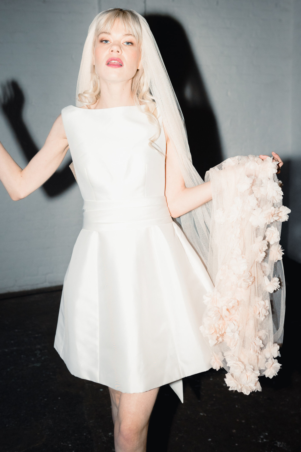 Woman in white mini dress with floral veil | wedding accessories brands
