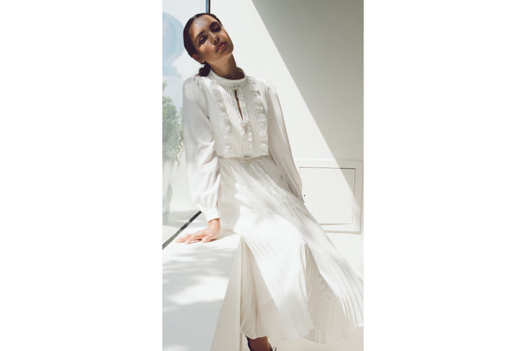 Woman sat in white dress