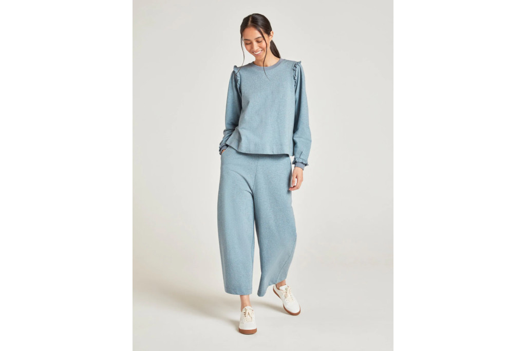 Woman in light blue jumper and trousers