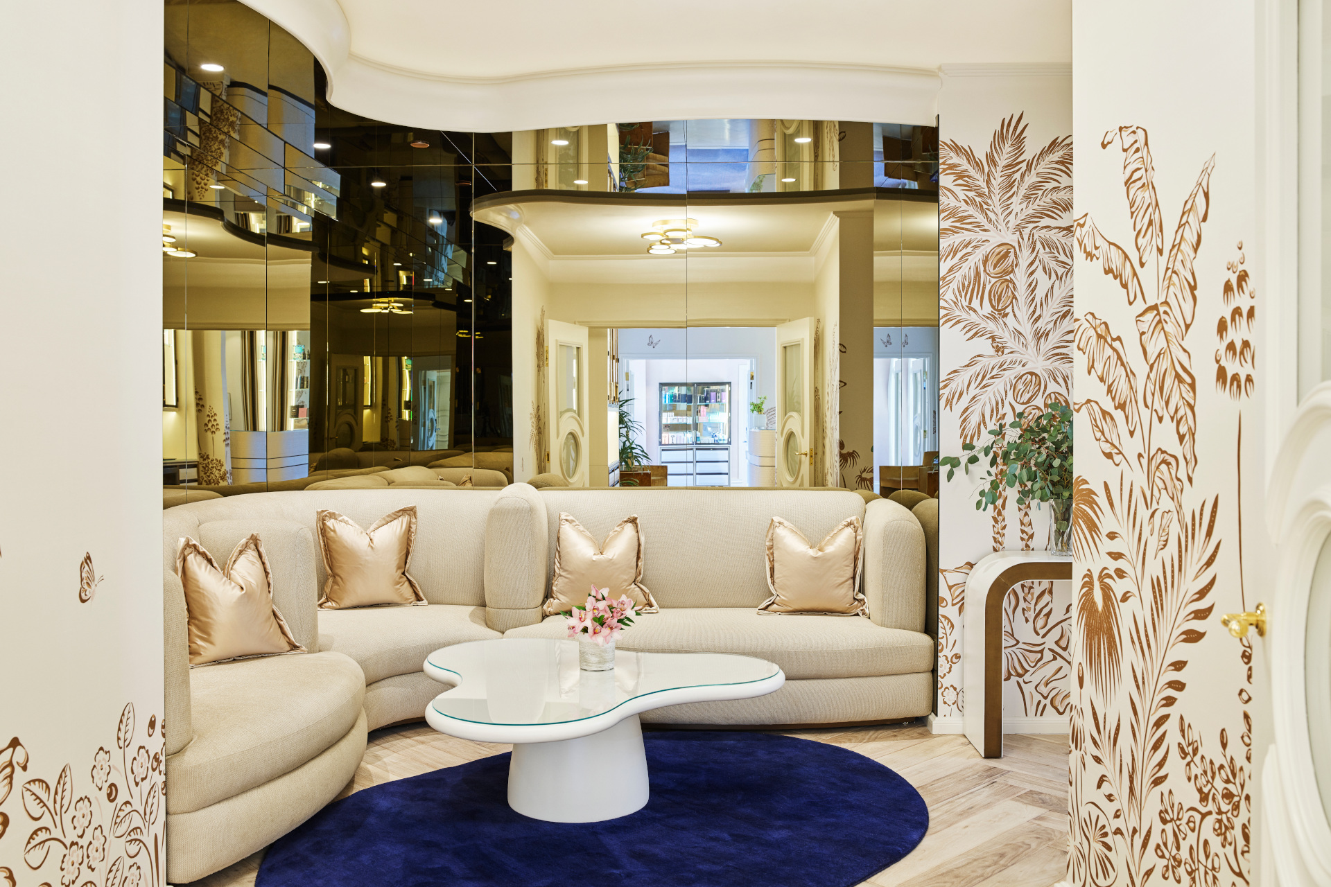 Cream sofa in front of floor-to-ceiling mirror