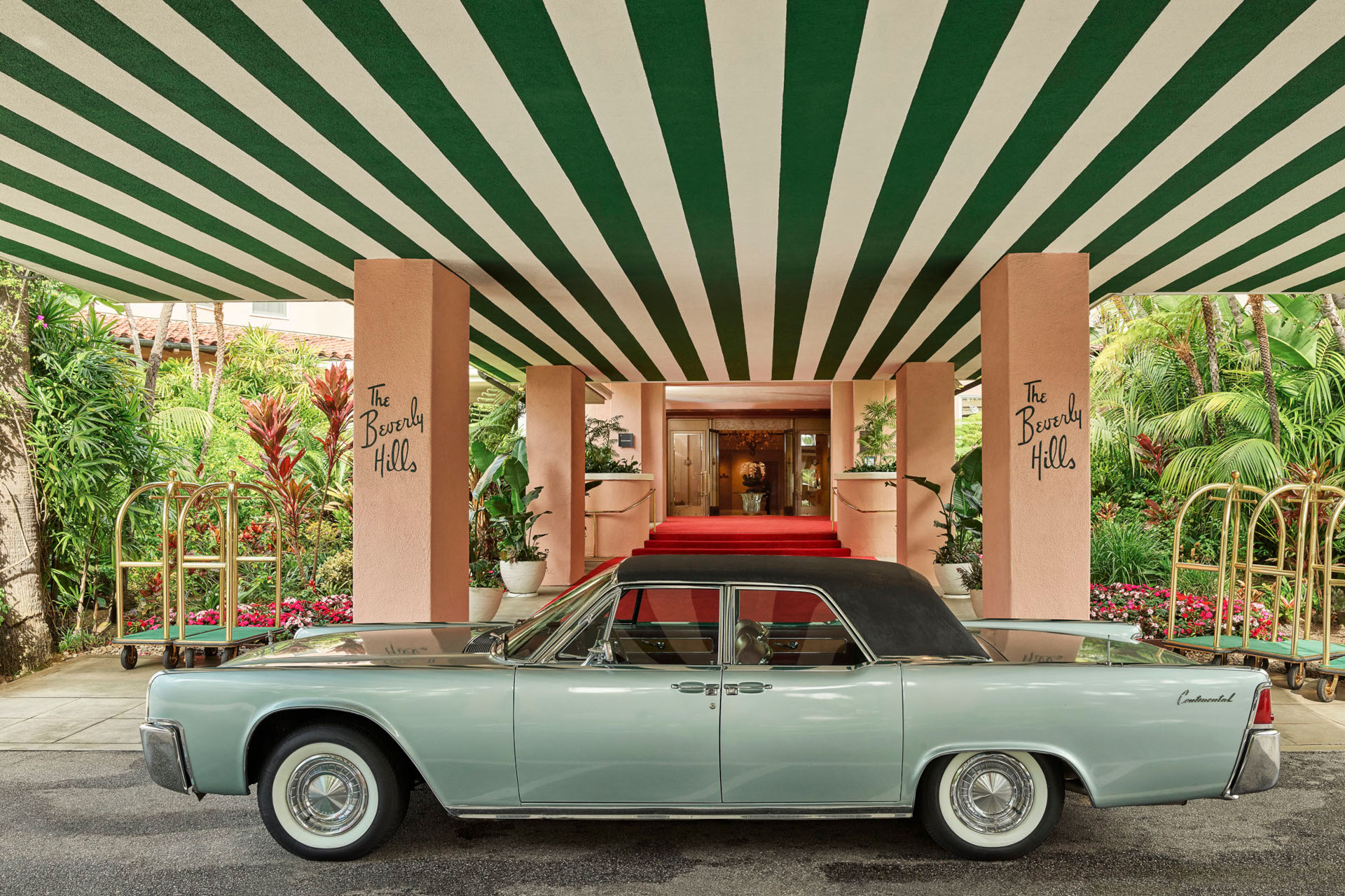 Blue car in front of The Beverley Hills Hotel entrance