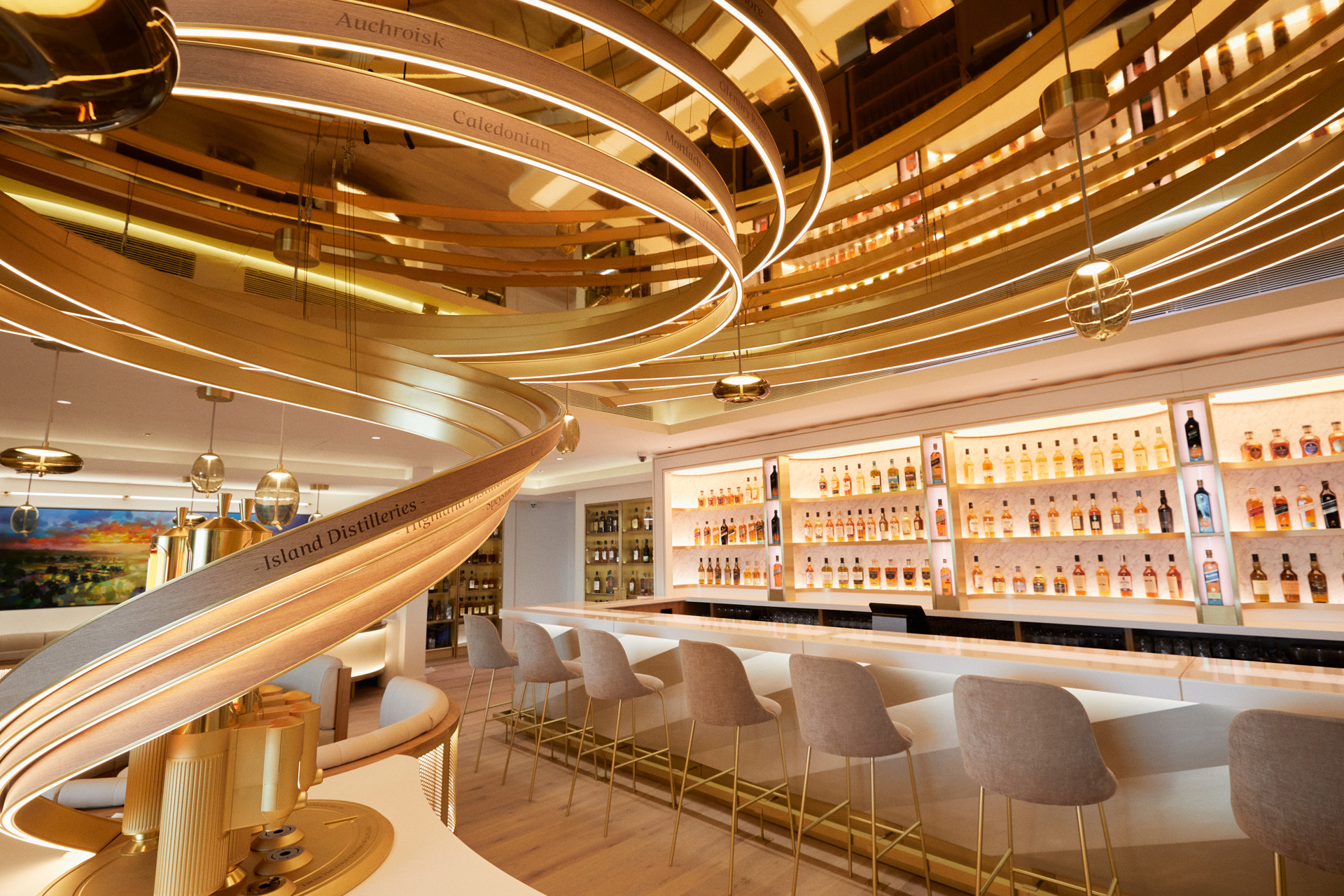 a bright, neutral toned whisky bar with bottles lining the wall