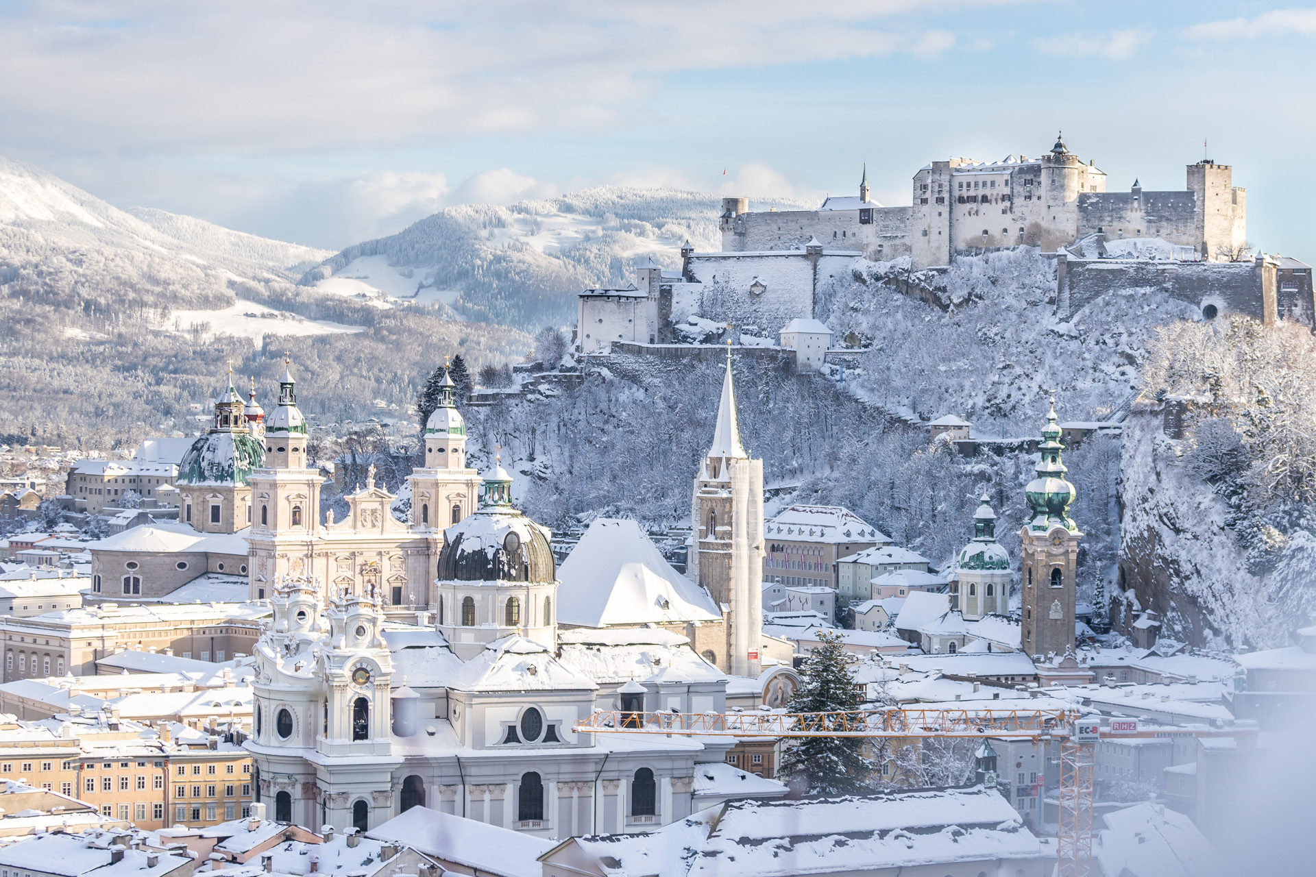 Snowy old city and fortress of Salzburg in winter, sunny day