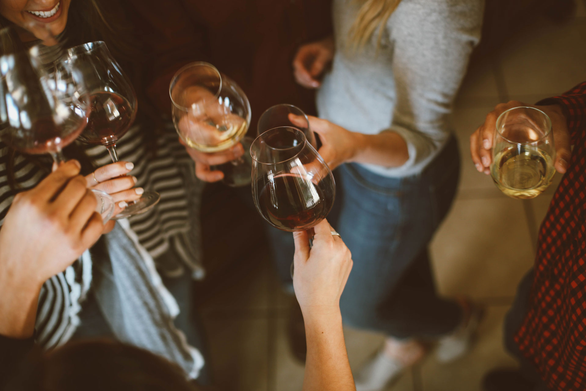Gathering of friends holding wine glasses 