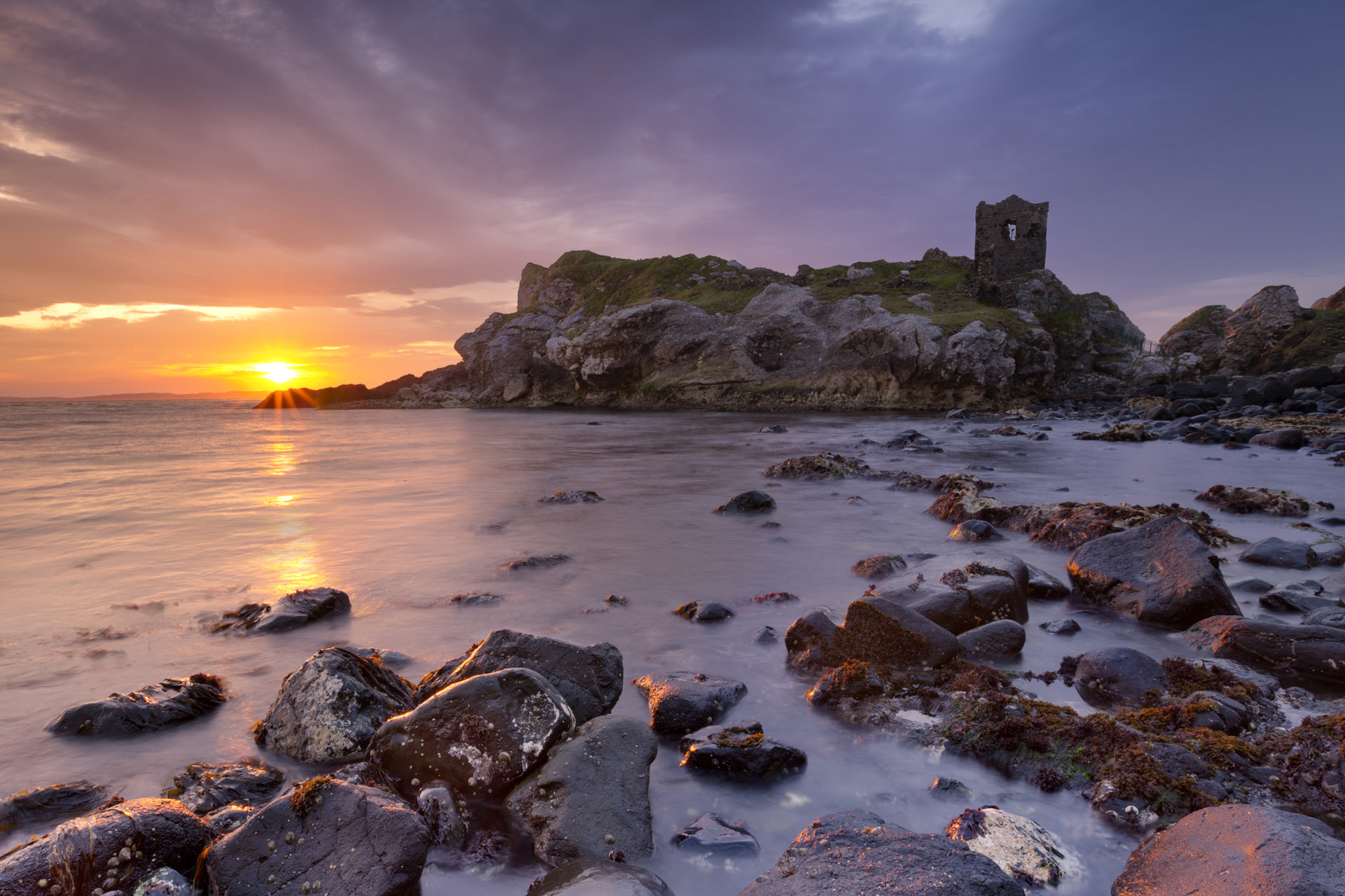 Spectacular sunrise at Kinbane Head with the ruins of Kinbane Castle on the Causeway Coast in Northern Ireland.