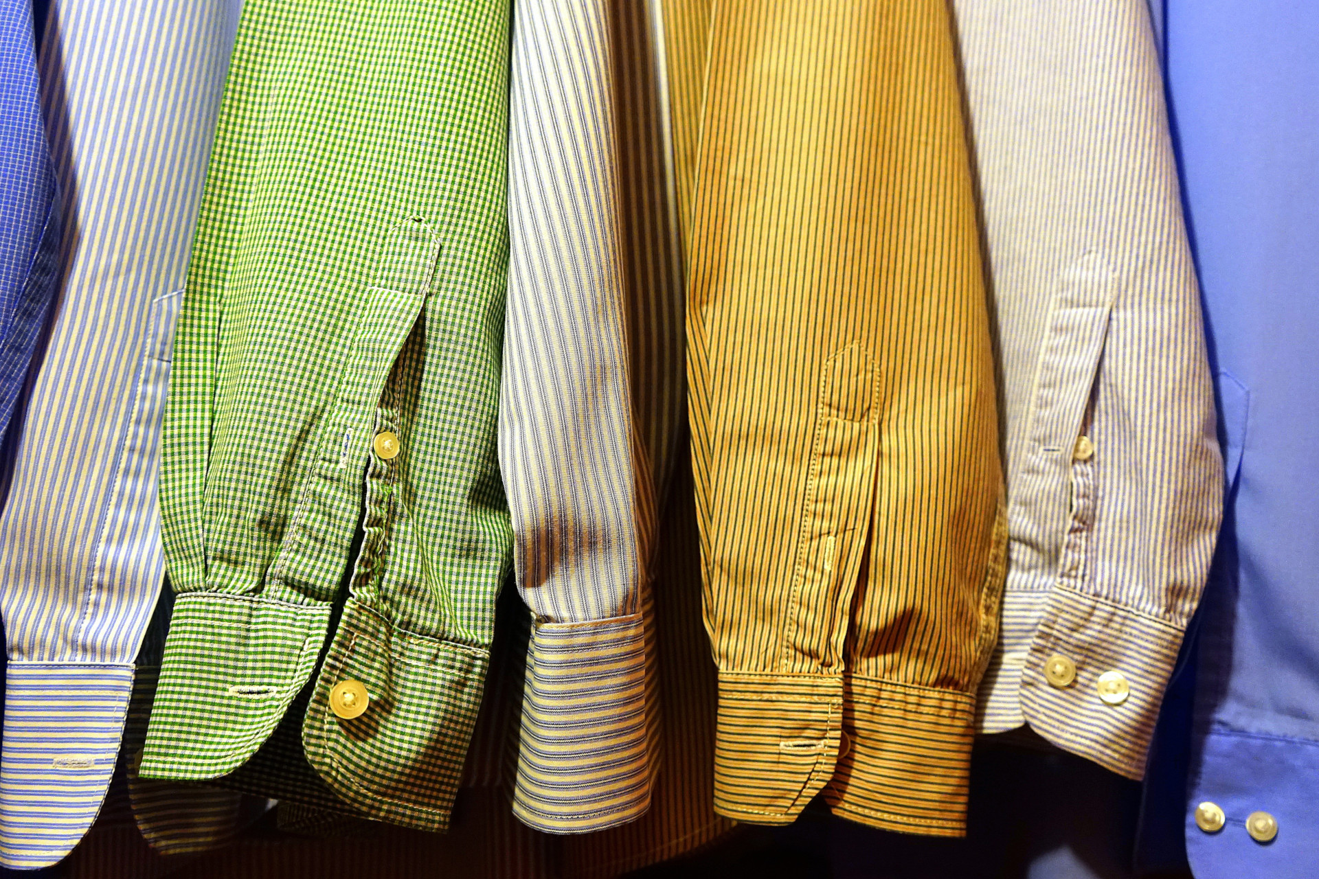 Close up of a row of colourful shirt sleeves