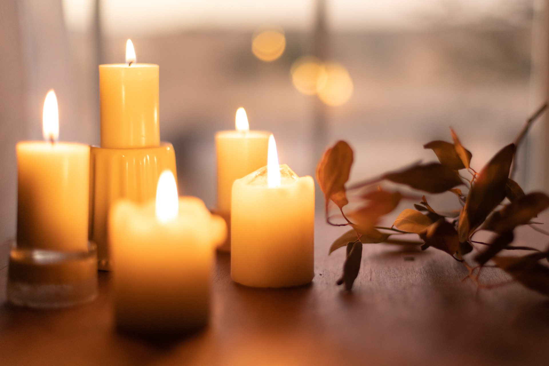 Lit candles set together on table