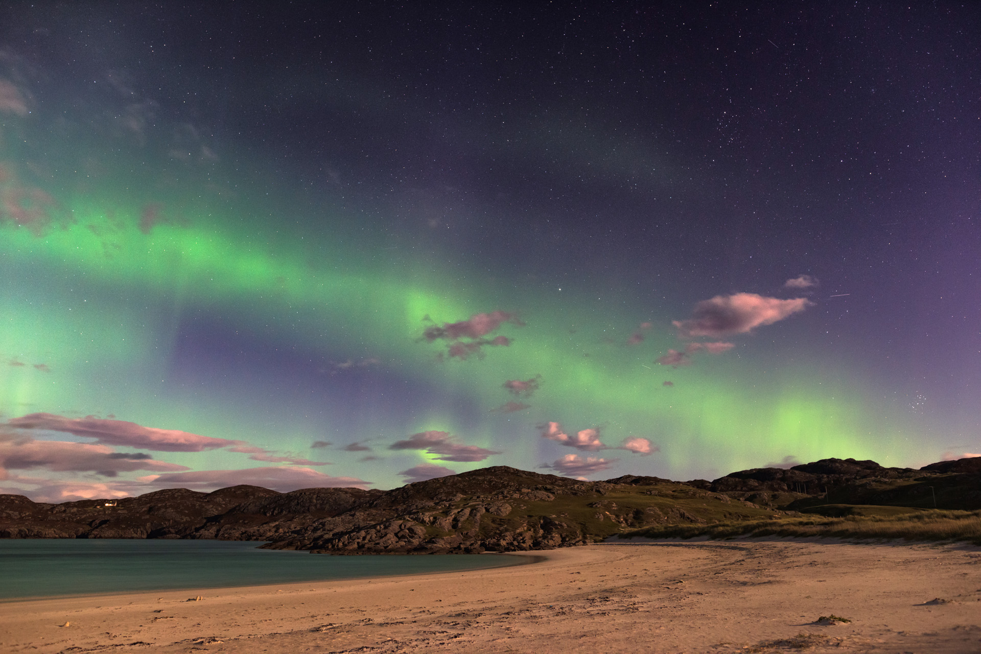 the Aurora Borealis, also known as the Northern lights, putting on a show over Achmelvich beach, Sutherland, in the Highlands of Scotland, UK.