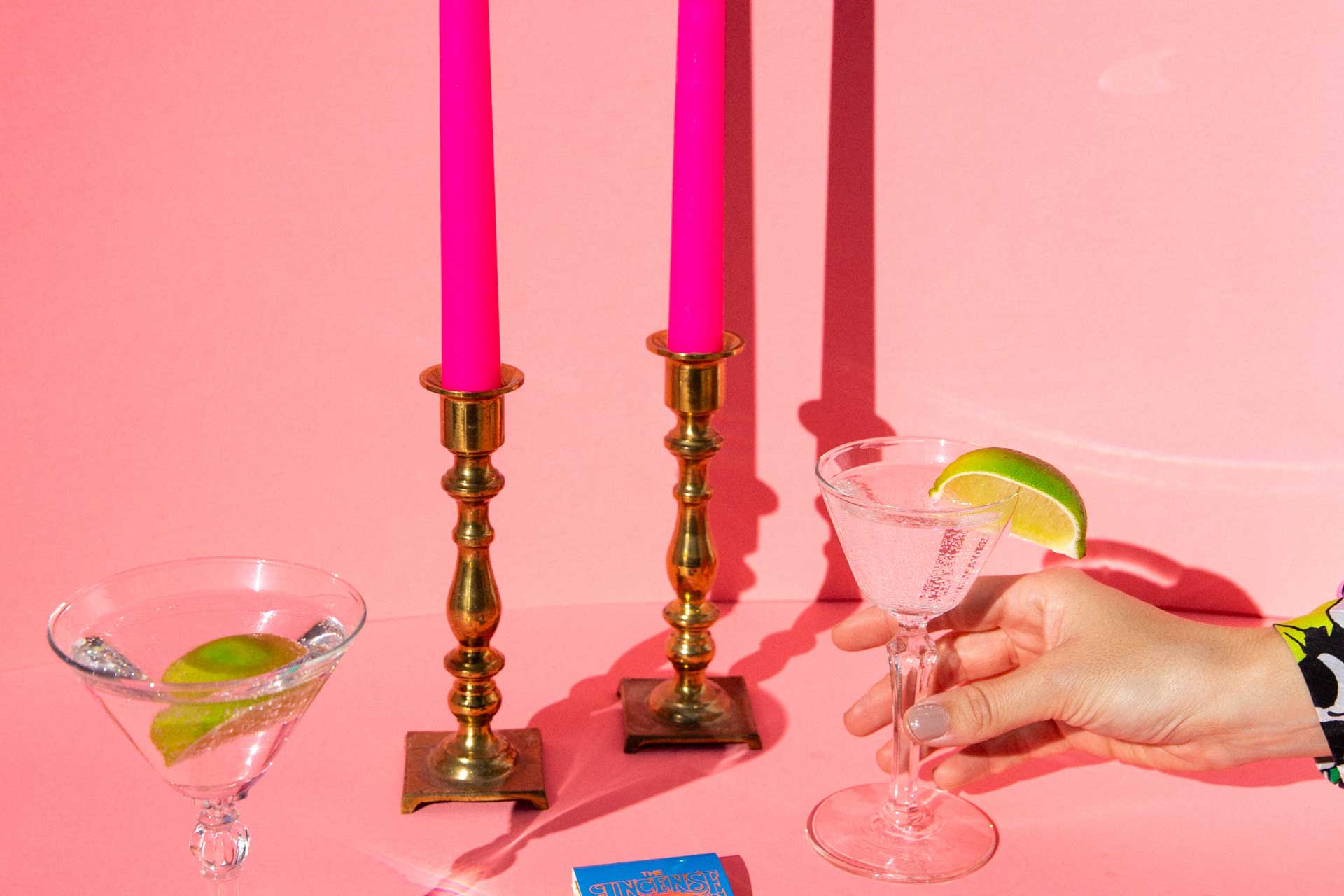 Pink candles in gold candlesticks in a pink interiors image