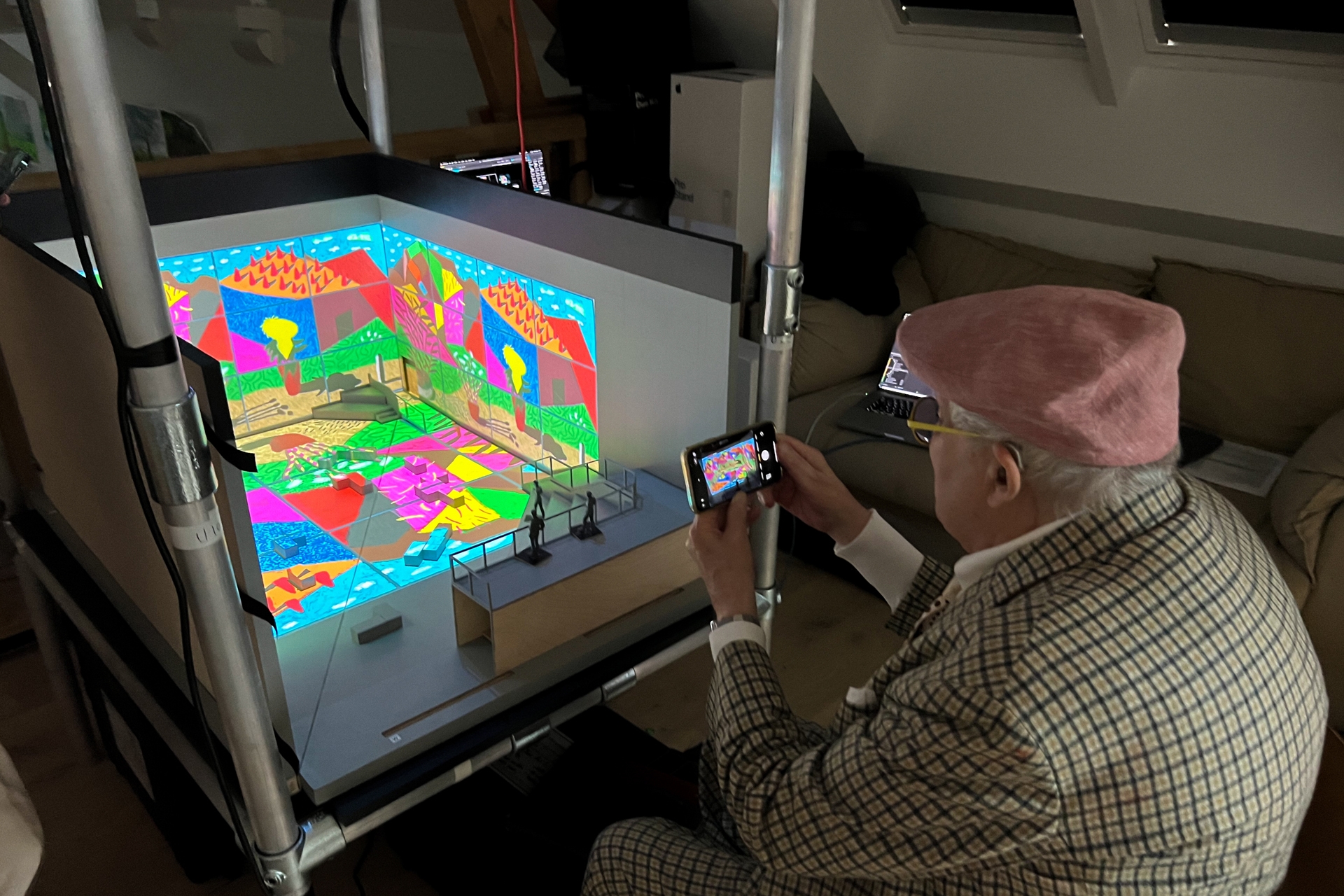 David Hockney looking at his immersive exhibition