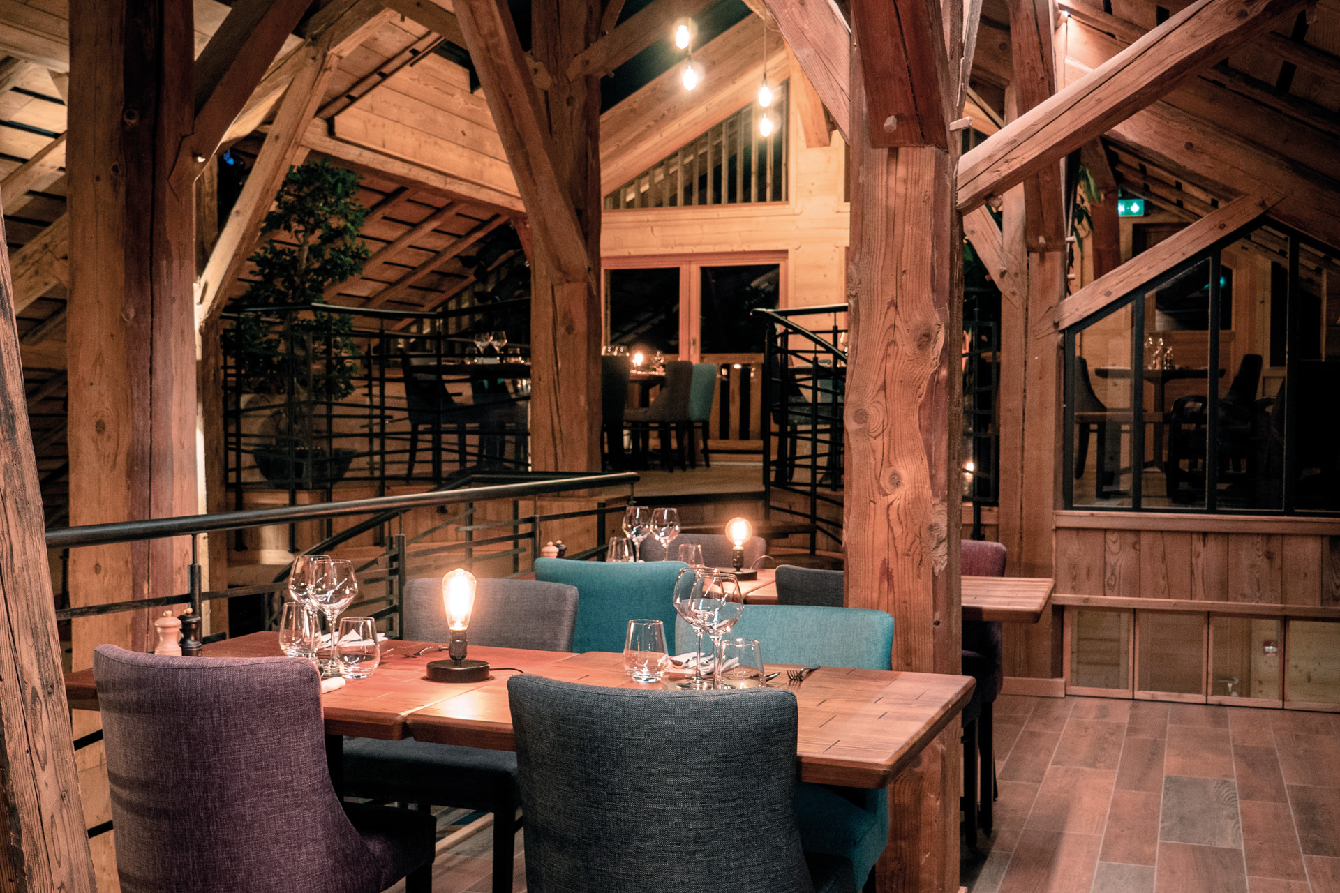 a dining room with mood lighting and wooden beams