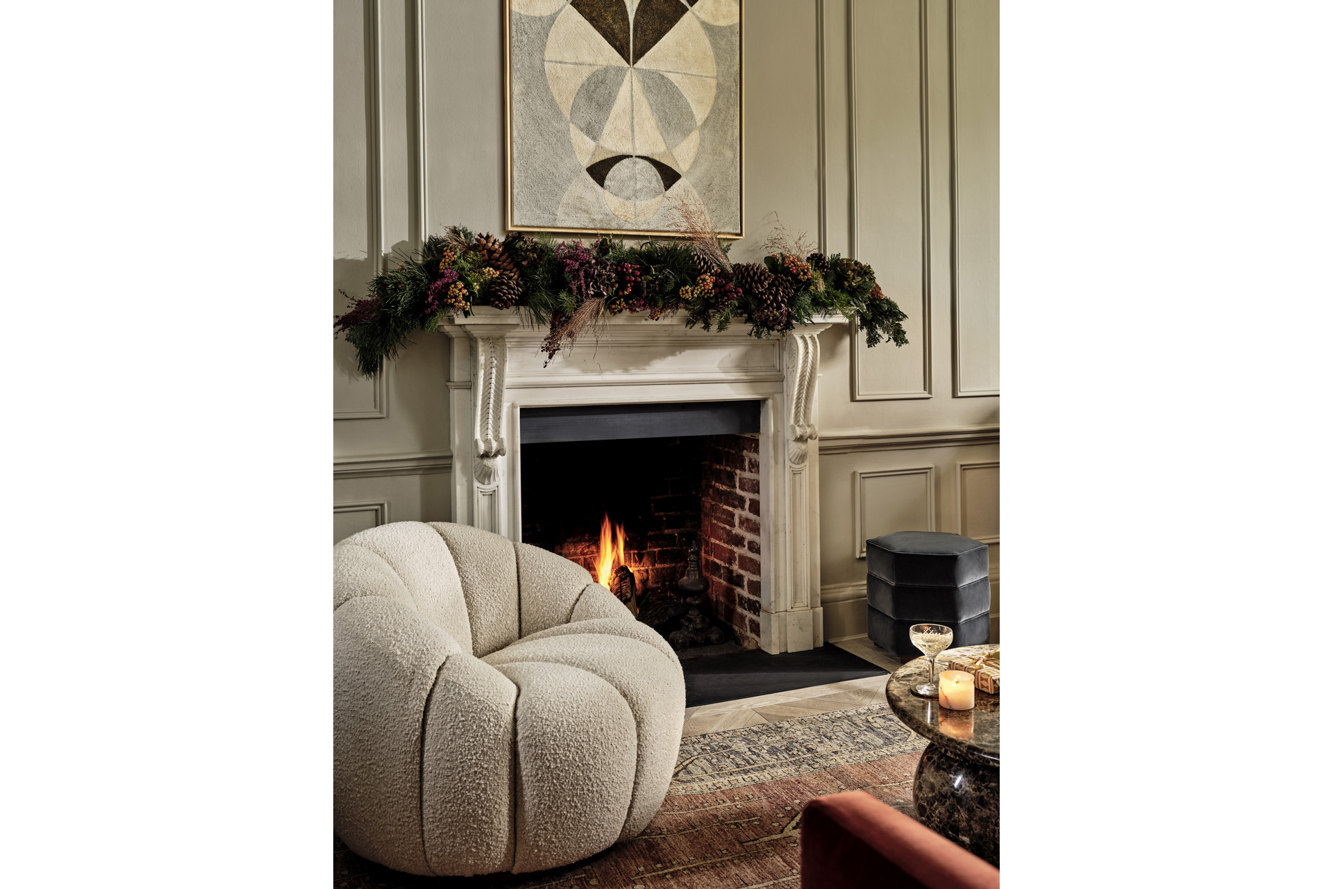 an armchair with a festive fireplace