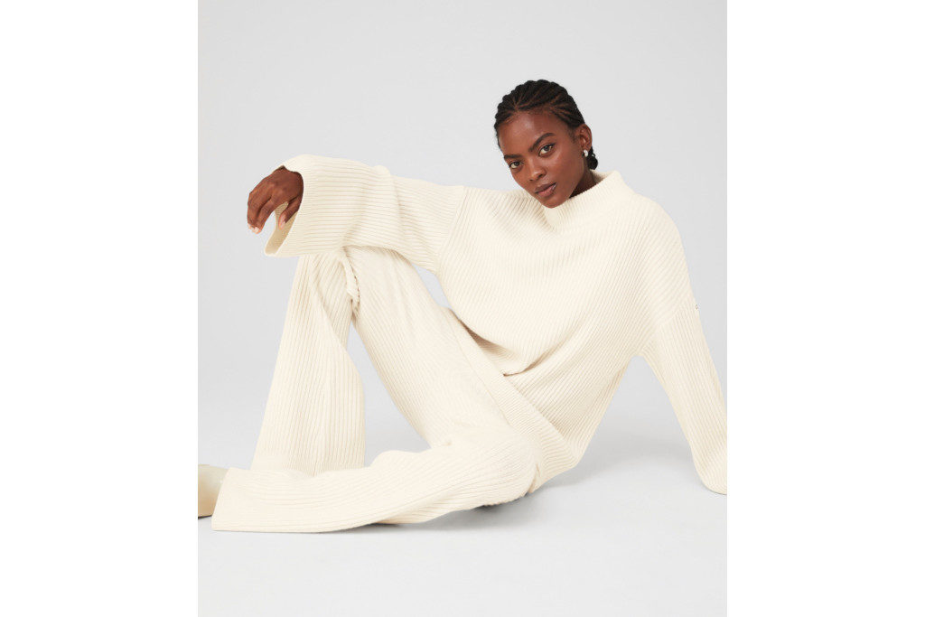 Woman in white jumper and trousers