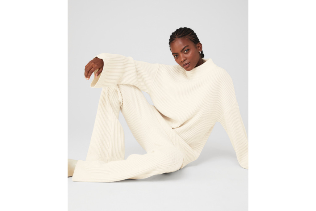 Woman in white jumper and trousers