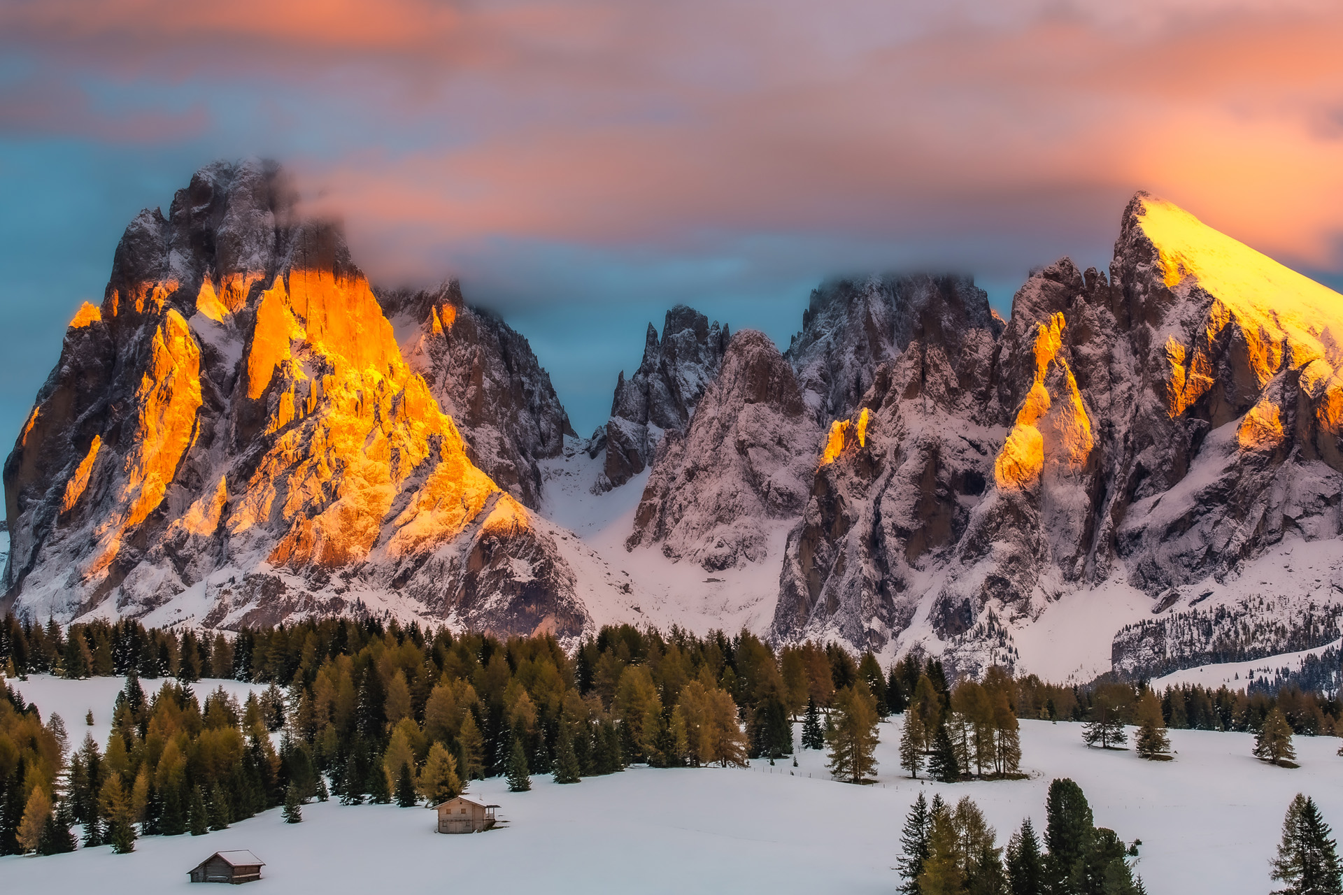 Dolomites mountains with snow at sunset Alpe di Siusi