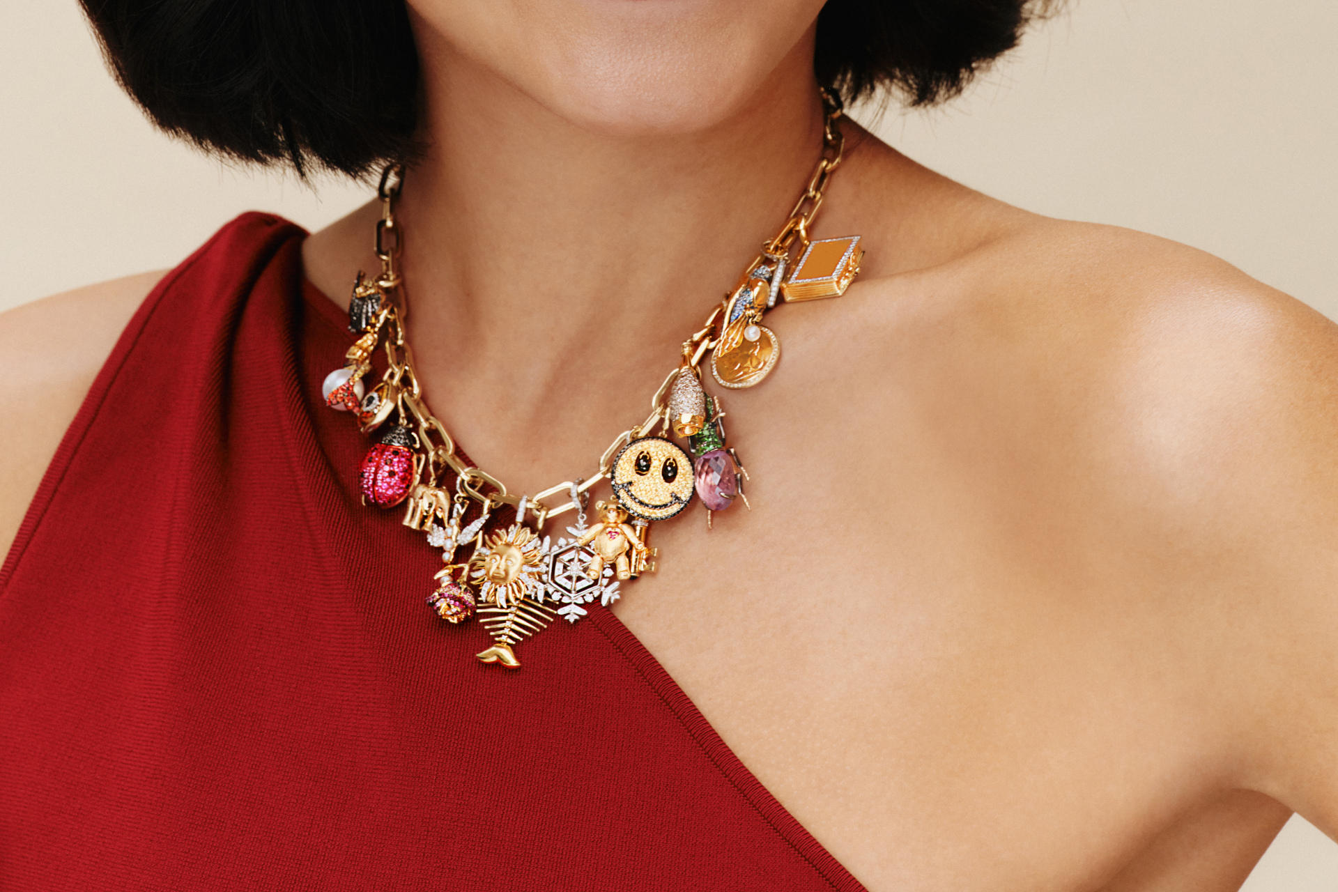 Close up of woman's neck with necklace decorated with charms