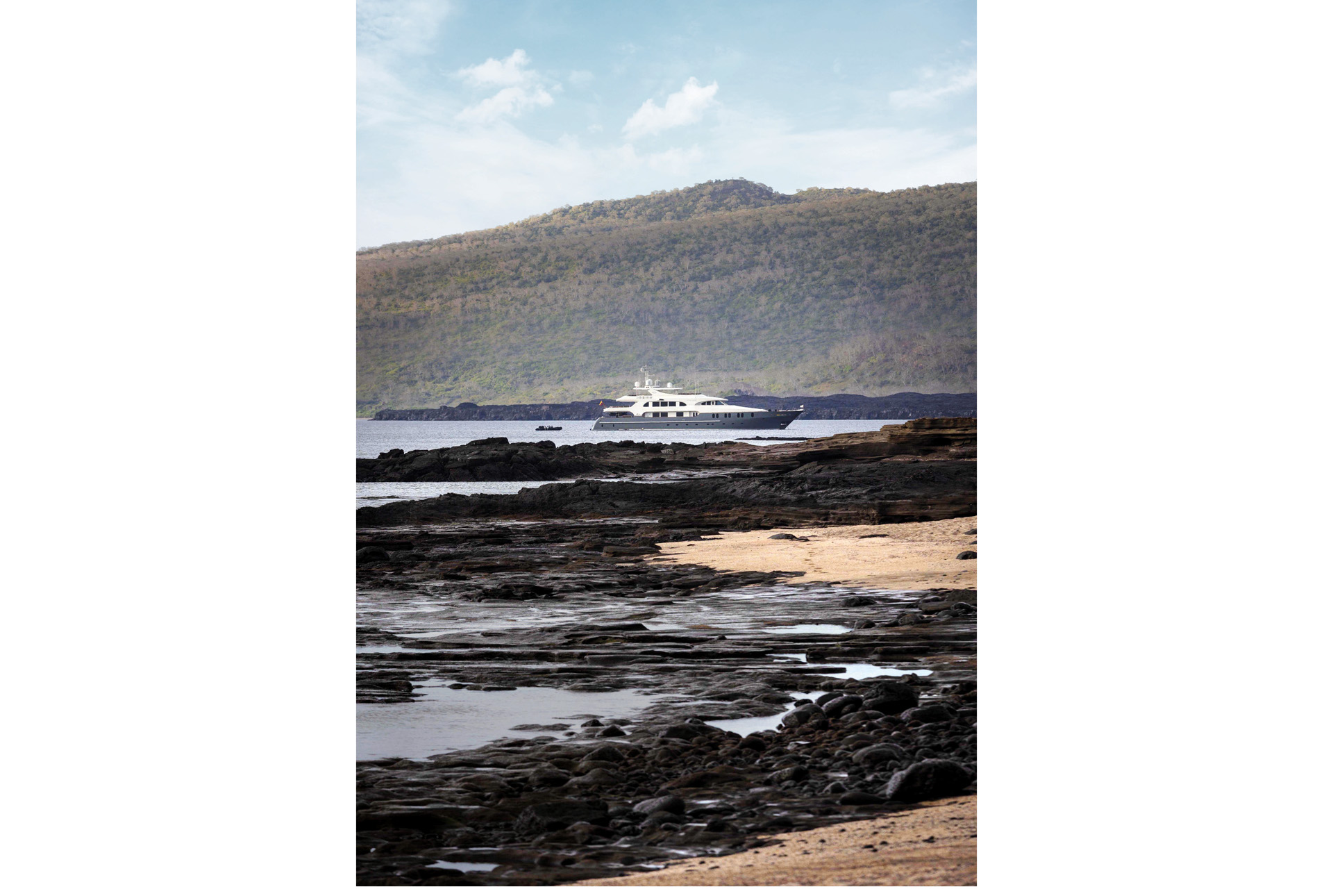 a yacht on the coast of the galapagos with natural surroundings