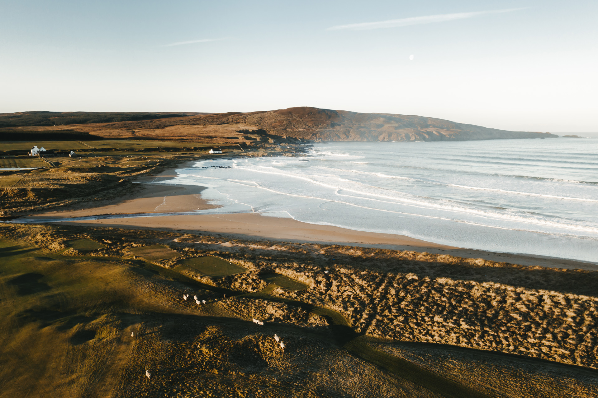 a beach with waves coming onto the shore
