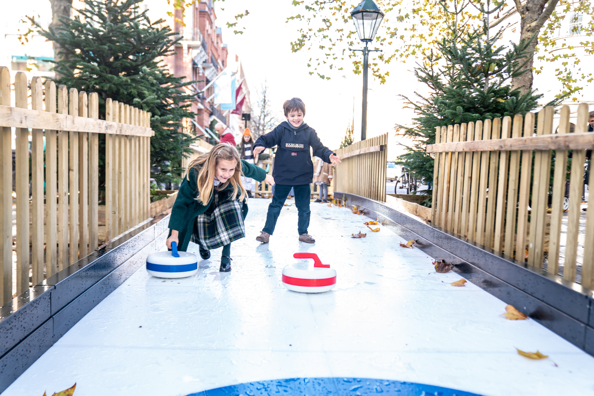 Children playing Bavarian curling outdoors