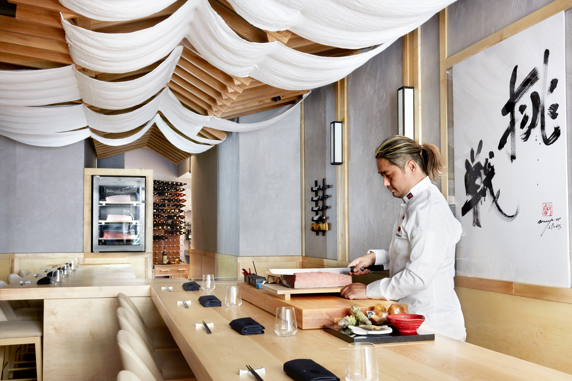 Chef Taiji Maruyama preparing food inside MARU