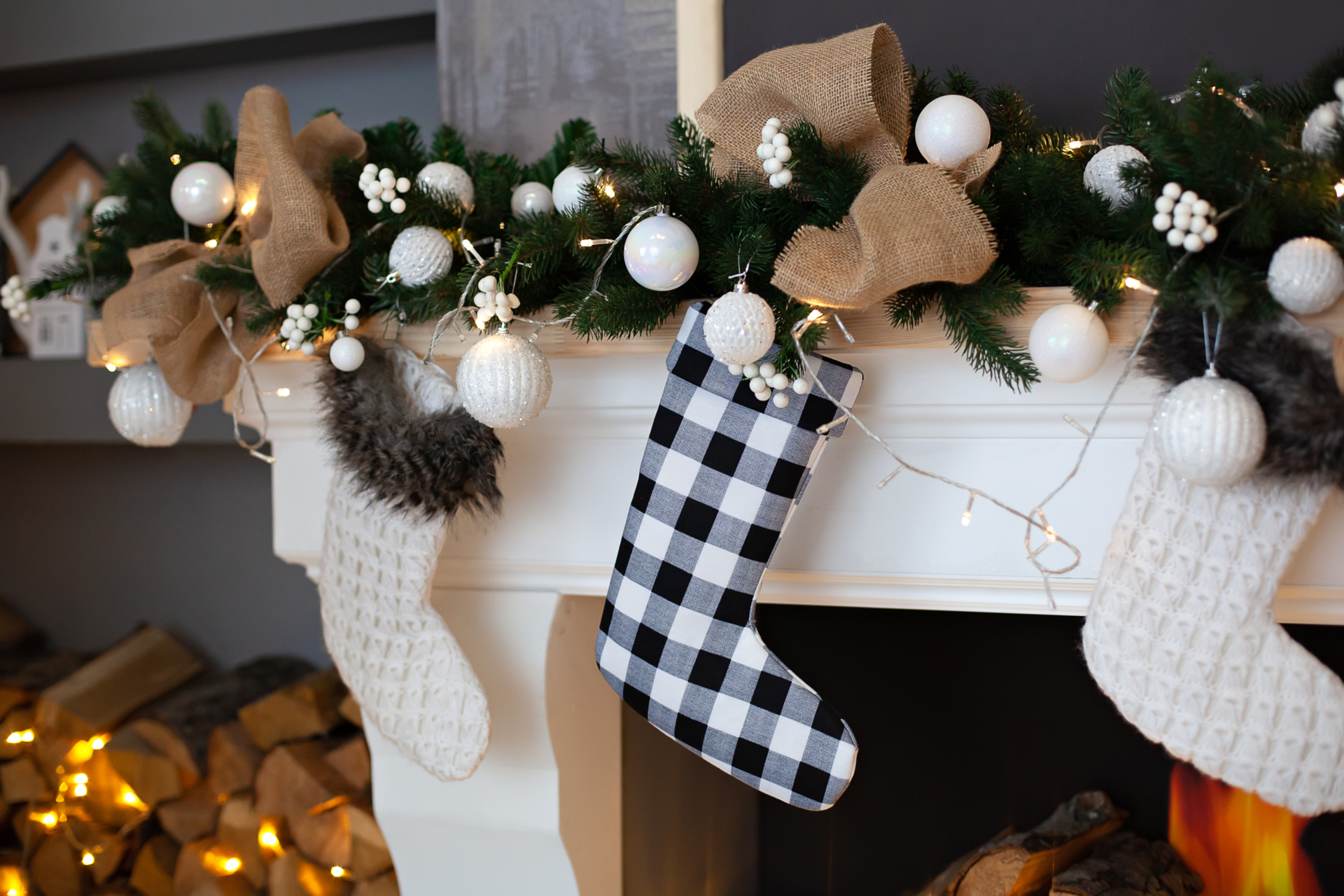 Stockings hanging from a festive decorated fireplace