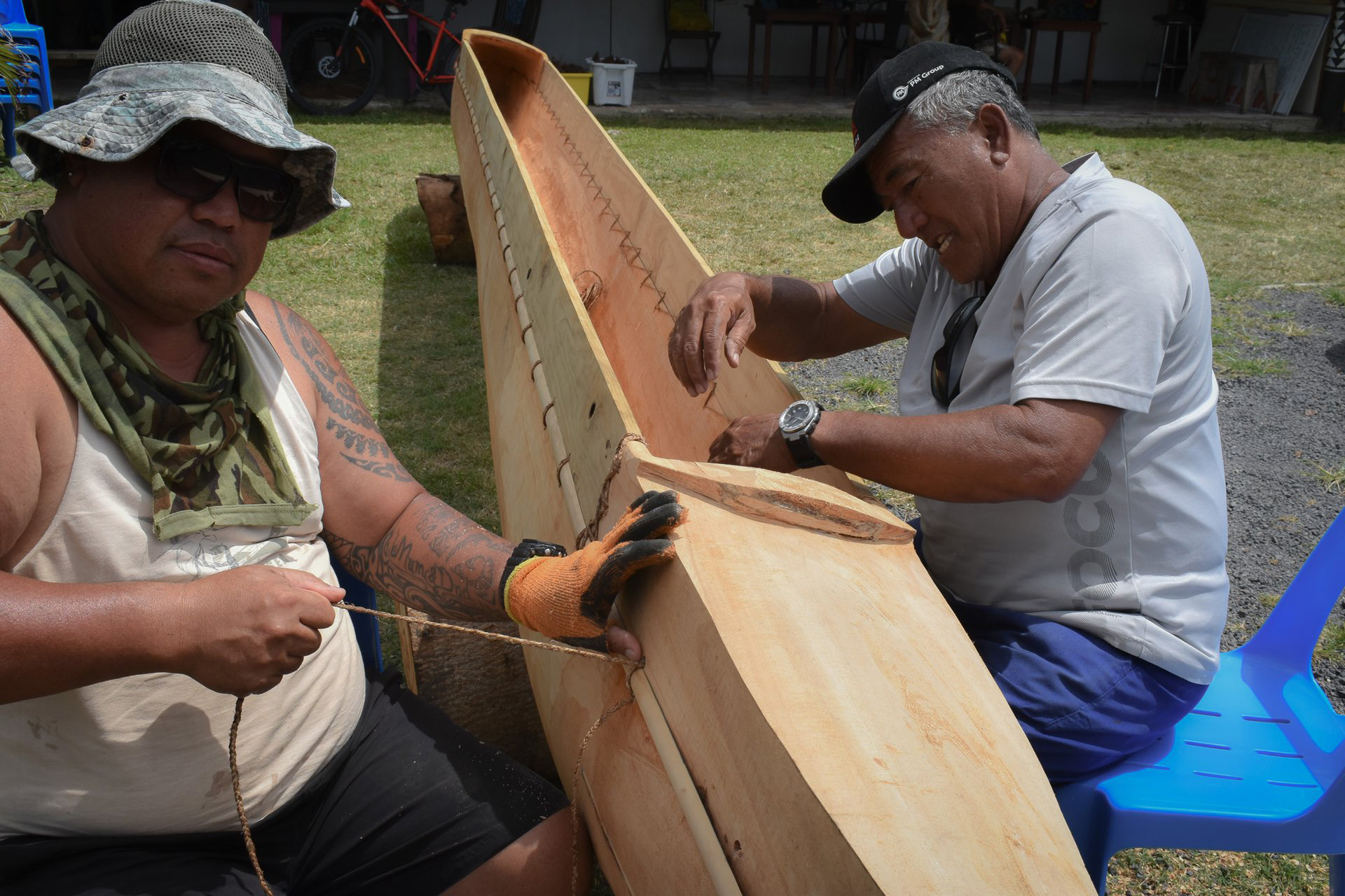 two men building a vaka boat