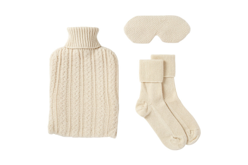 Cream coloured hot water bottle, socks and sleeping mask