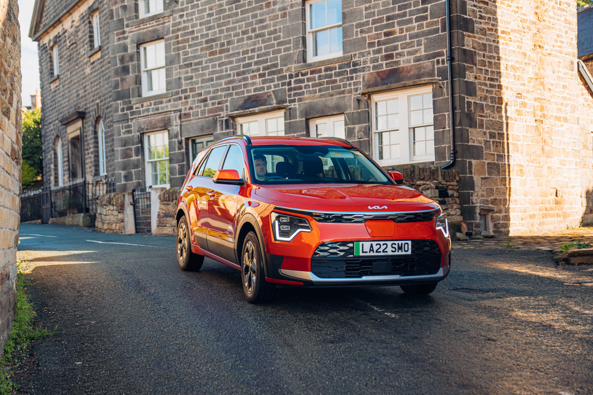 red kia niro on a road