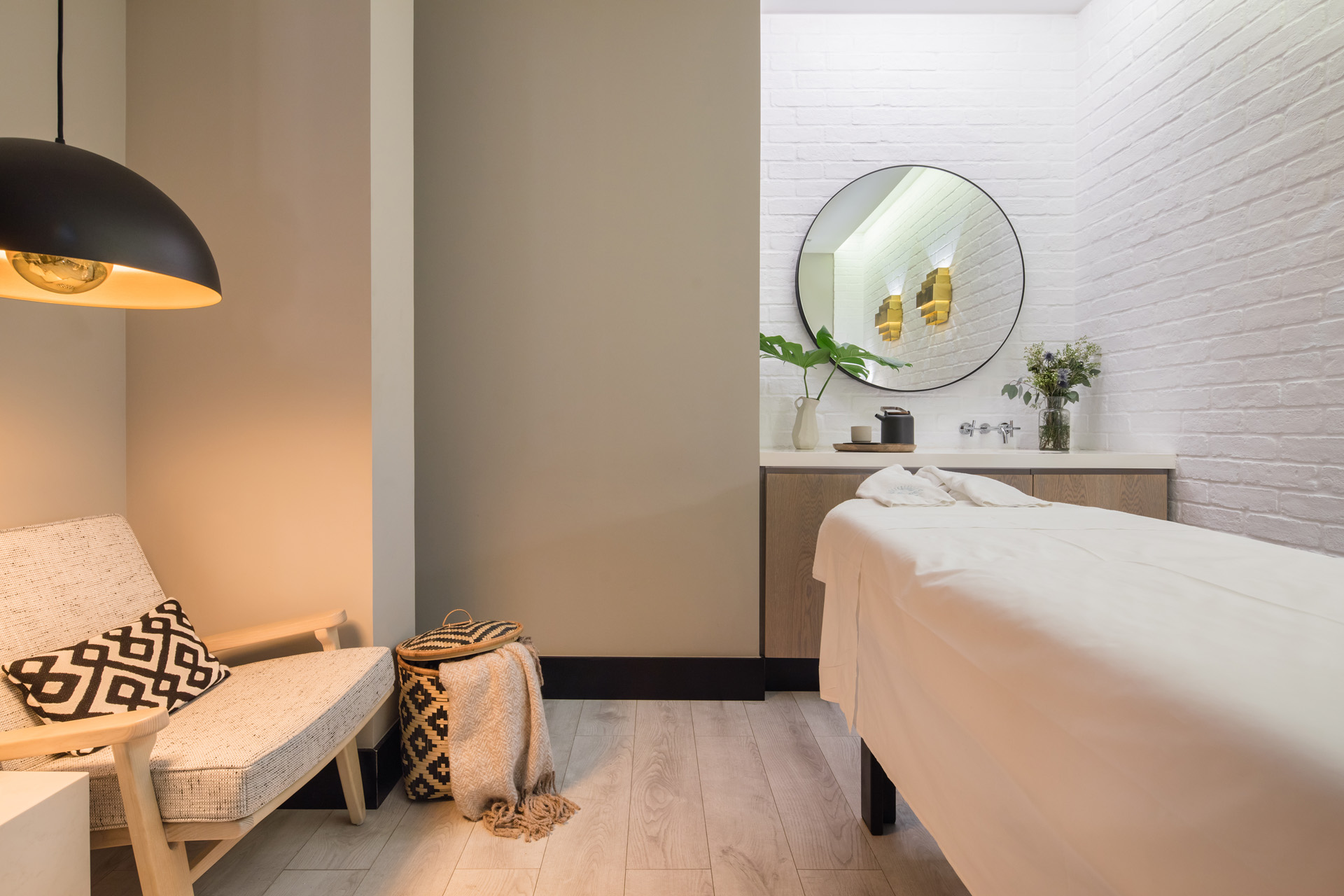 a bed and sitting chair in the spa at The Lumiares in Lisbon