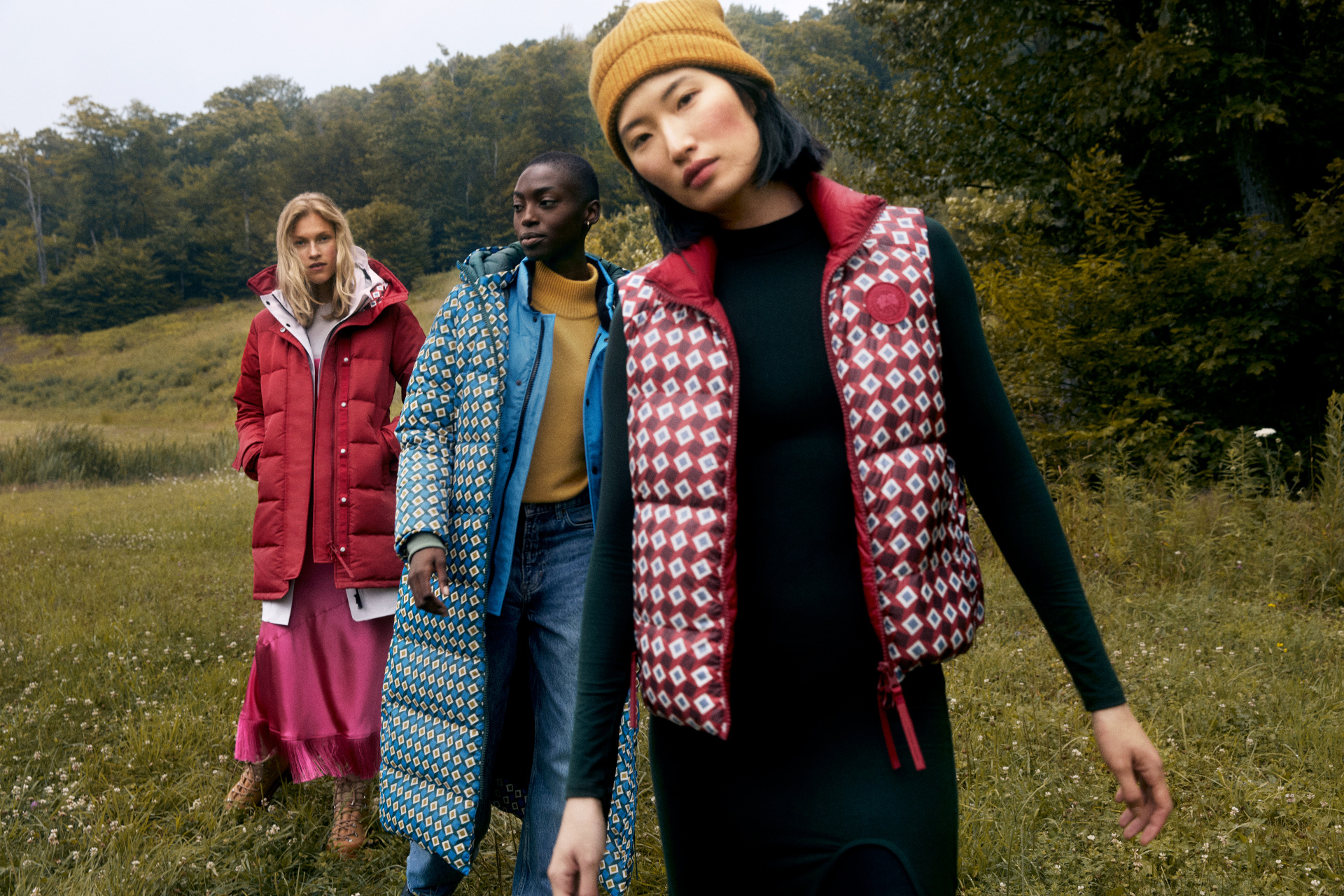 Three women in a field wearing winter clothes