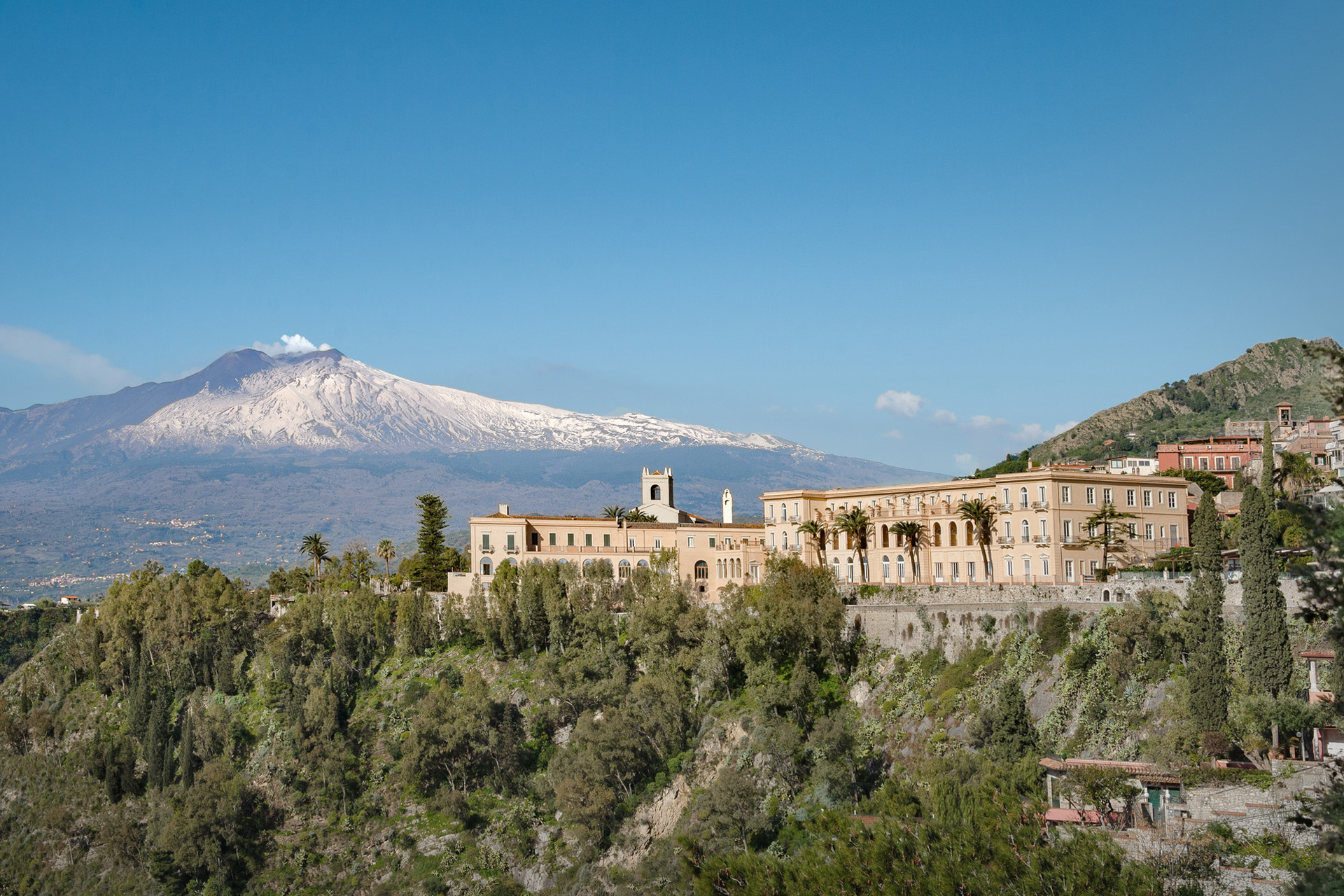 the exterior of San Domenico Palace, Taormina, A Four Seasons Hotel with mount etna