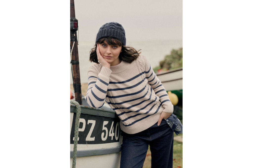 Woman in knot beanie and stripe jumper