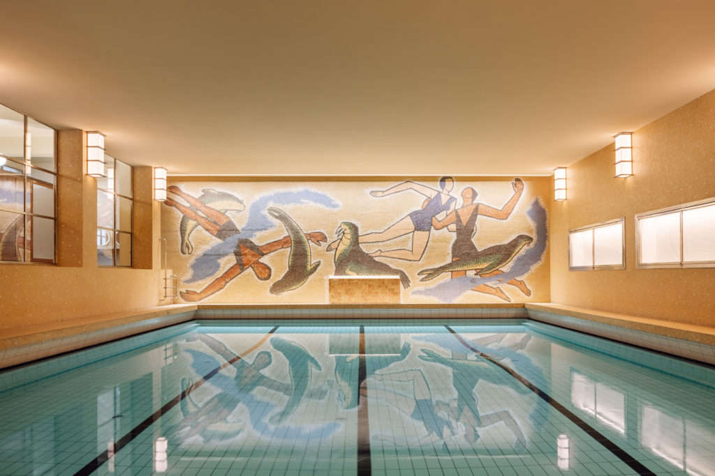 a mosaic wall and swimming pool